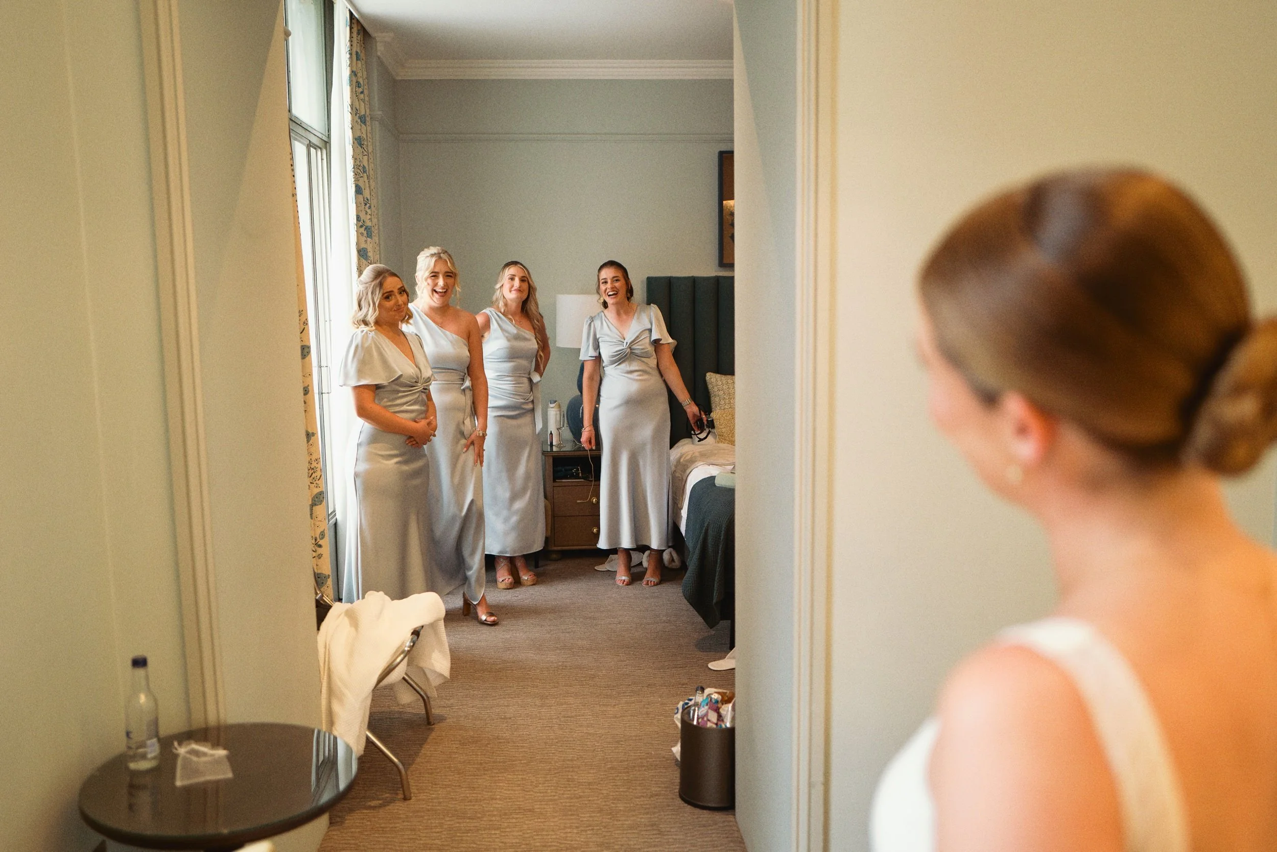 Surrey wedding photographer UK captures first look with bridesmaids at the Bush Farnham