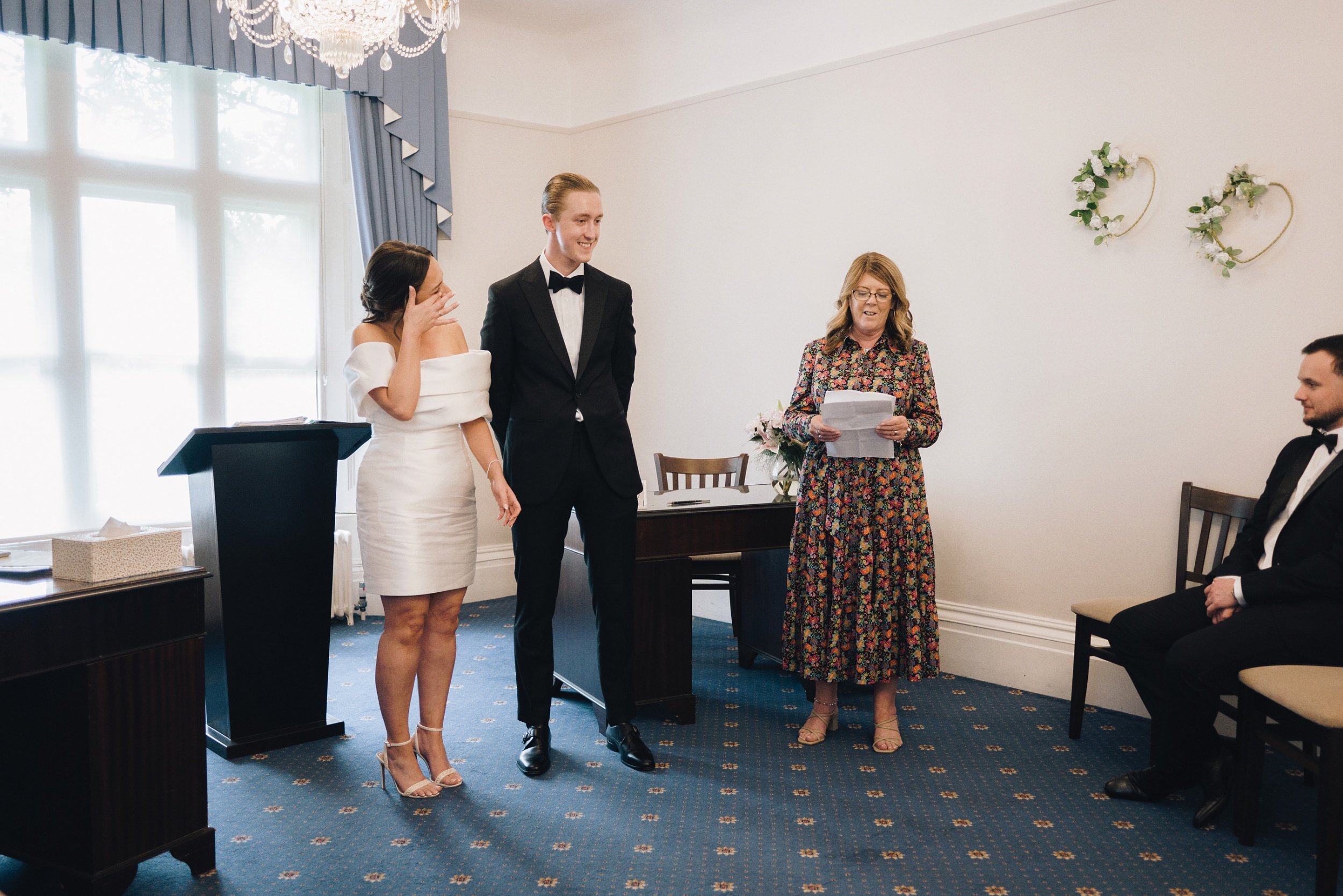 Bride wipes away a tear as she legally marries her husband at their Surrey wedding