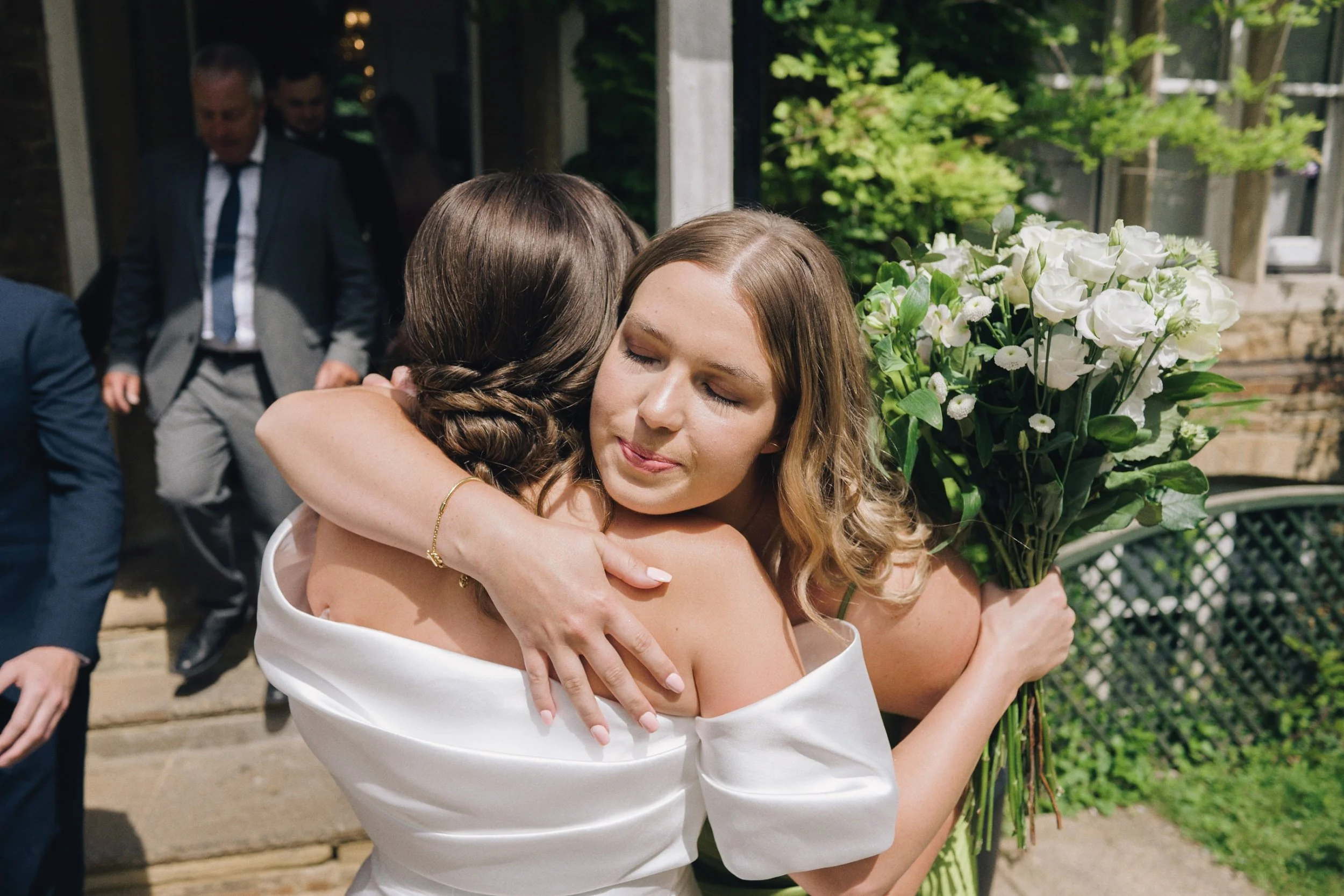 Wedding guests congratulate the bride as they leave Guildford Register Office