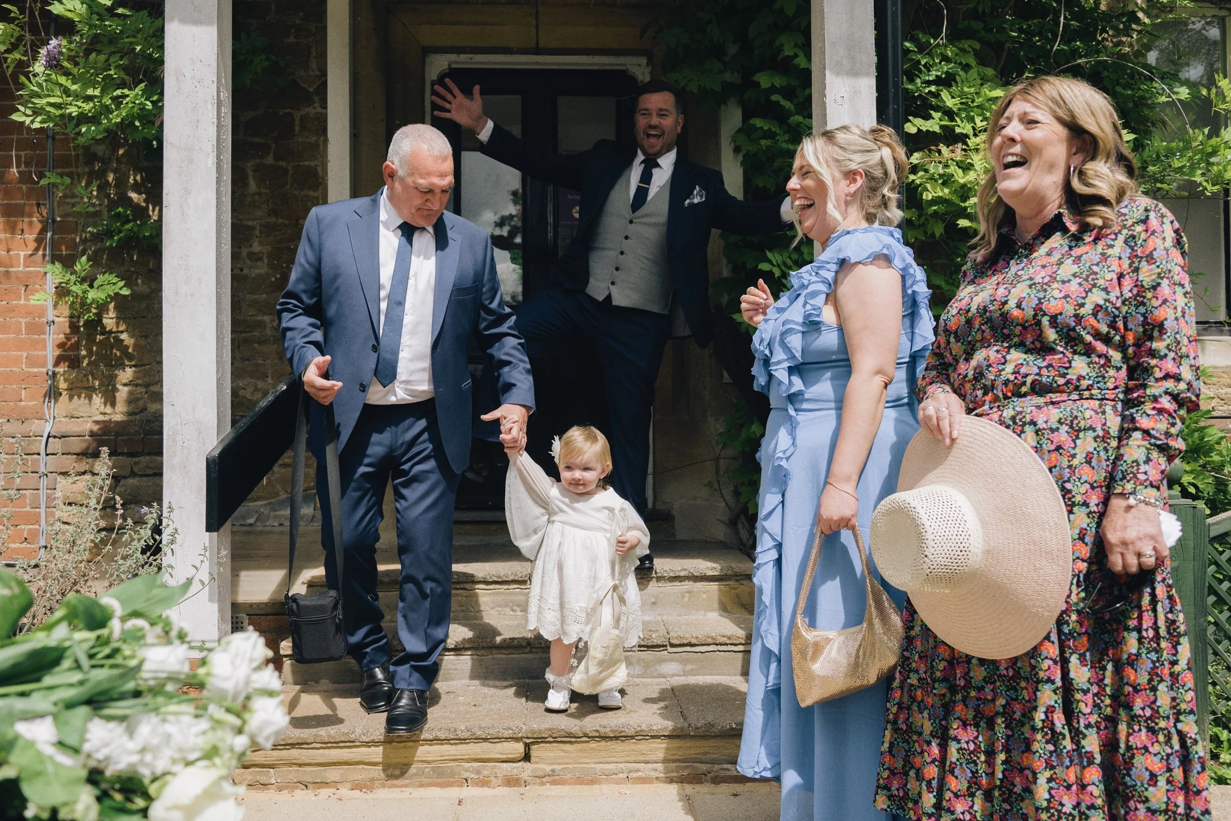 Flower girl walks down the steps at the Surrey wedding venue after the ceremony finishes