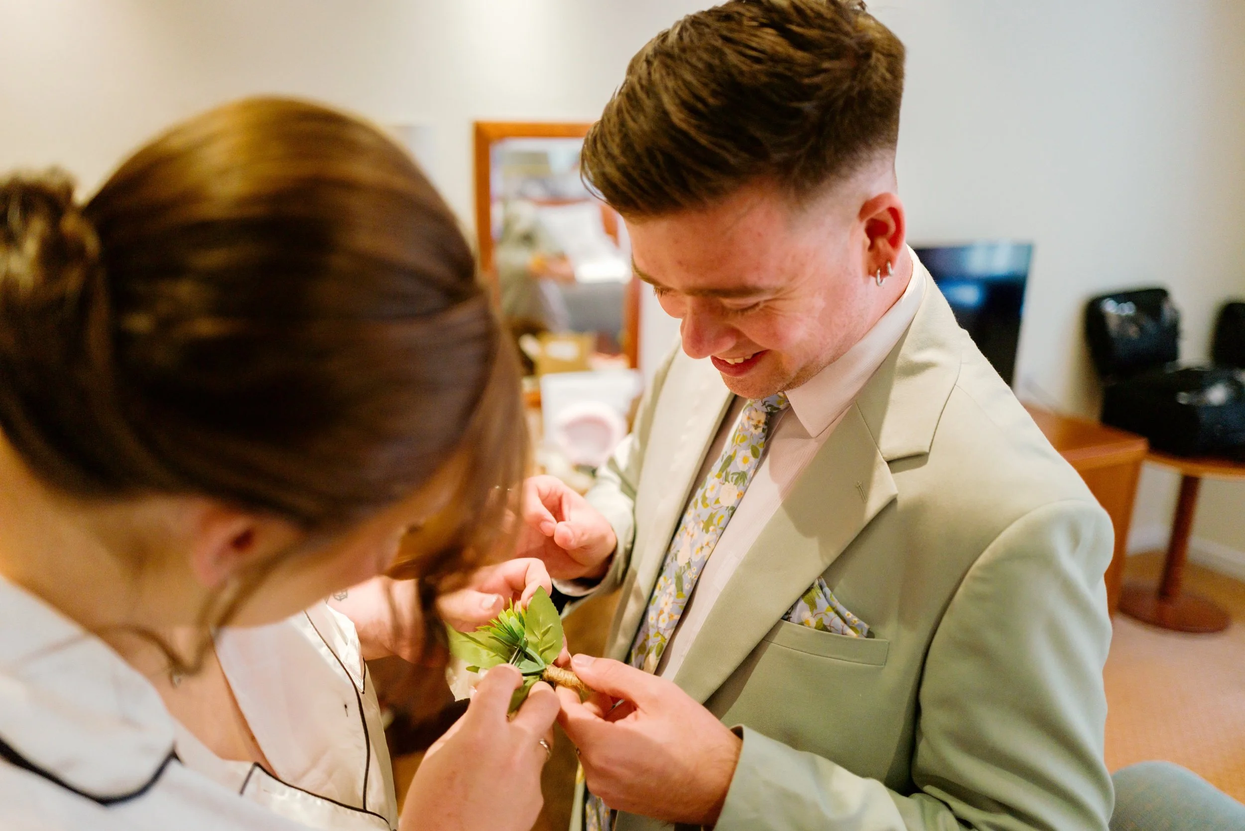 Hampshire wedding photographer captures candid wedding photo of bride and a friend laughing at the Hampshire wedding venue