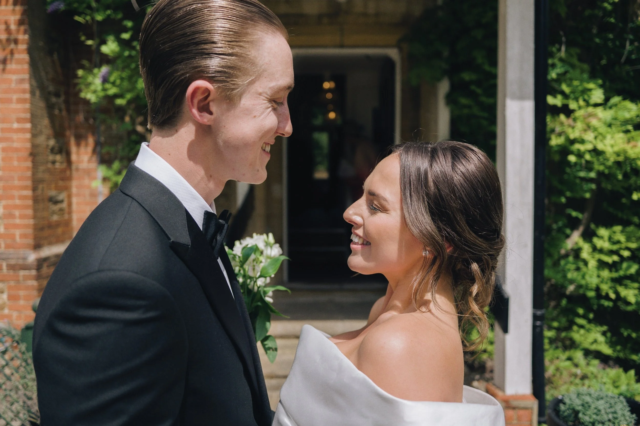 Wedding photographer captures candid wedding photos of the newly married couple outside their wedding venue in Guildford, Surrey