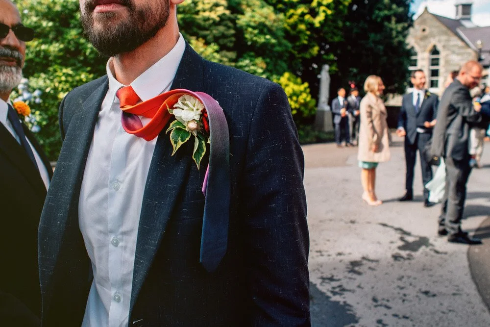 Documentary wedding photographer captures candid photo of groom's tie