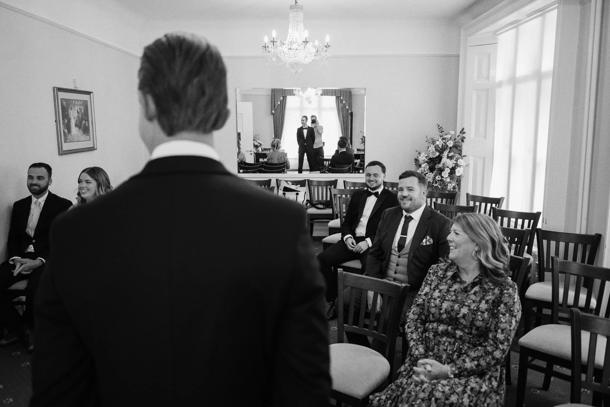 Guests all turn to look at the bride as she walks down the aisle