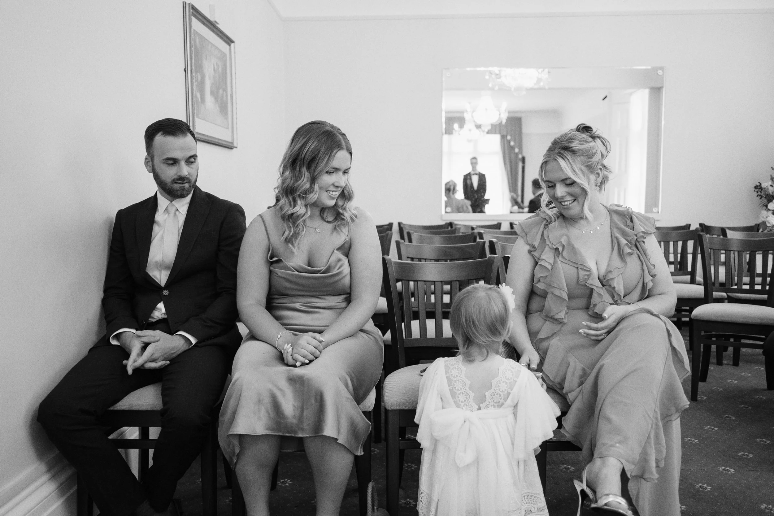 Guests keep the flower girl entertained before the ceremony