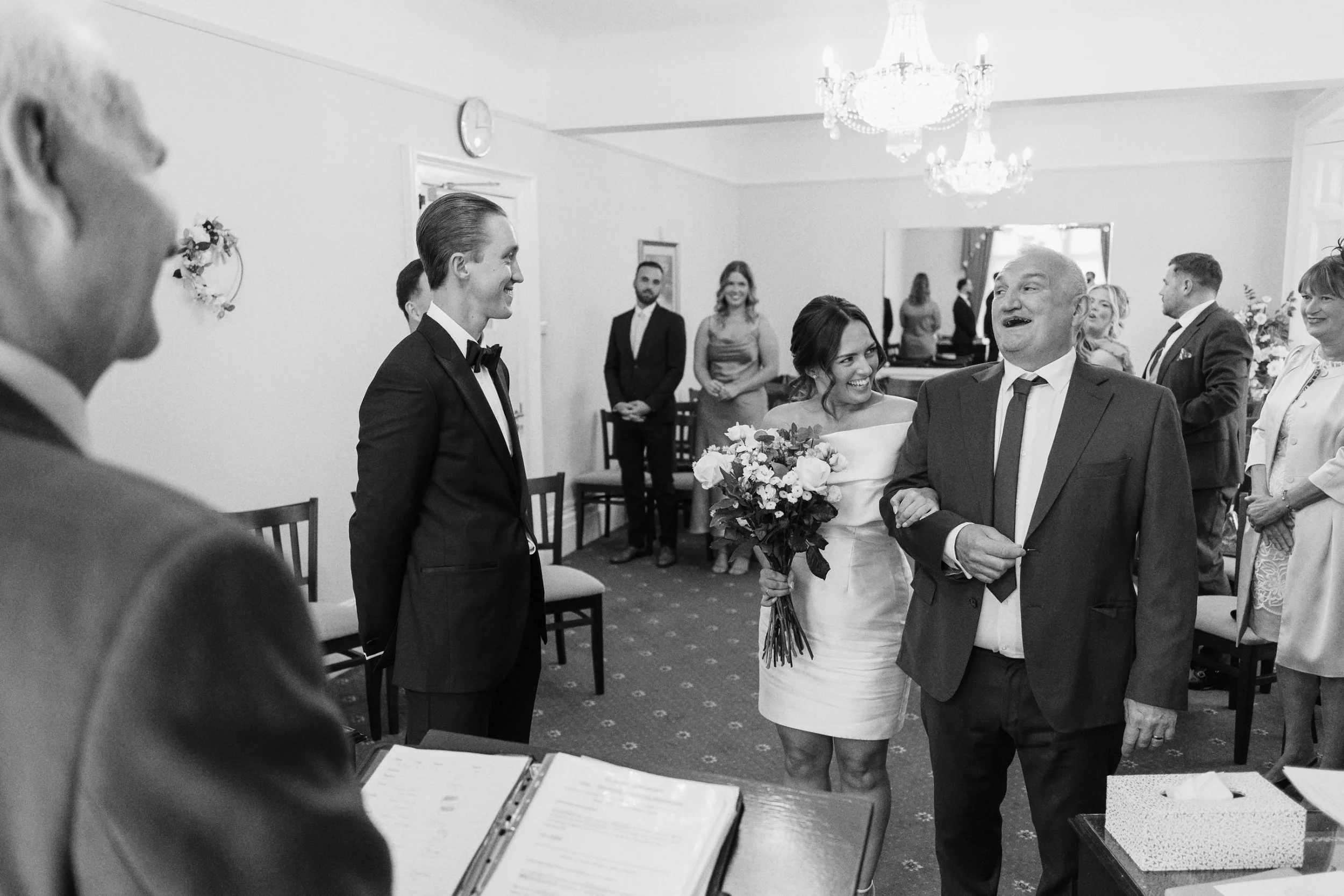 Father of the bride laughs before he gives away the bride