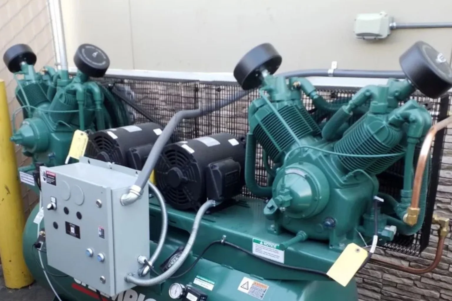 Electrician connecting a 3-phase commercial air compressor for a business in Barstow, California.