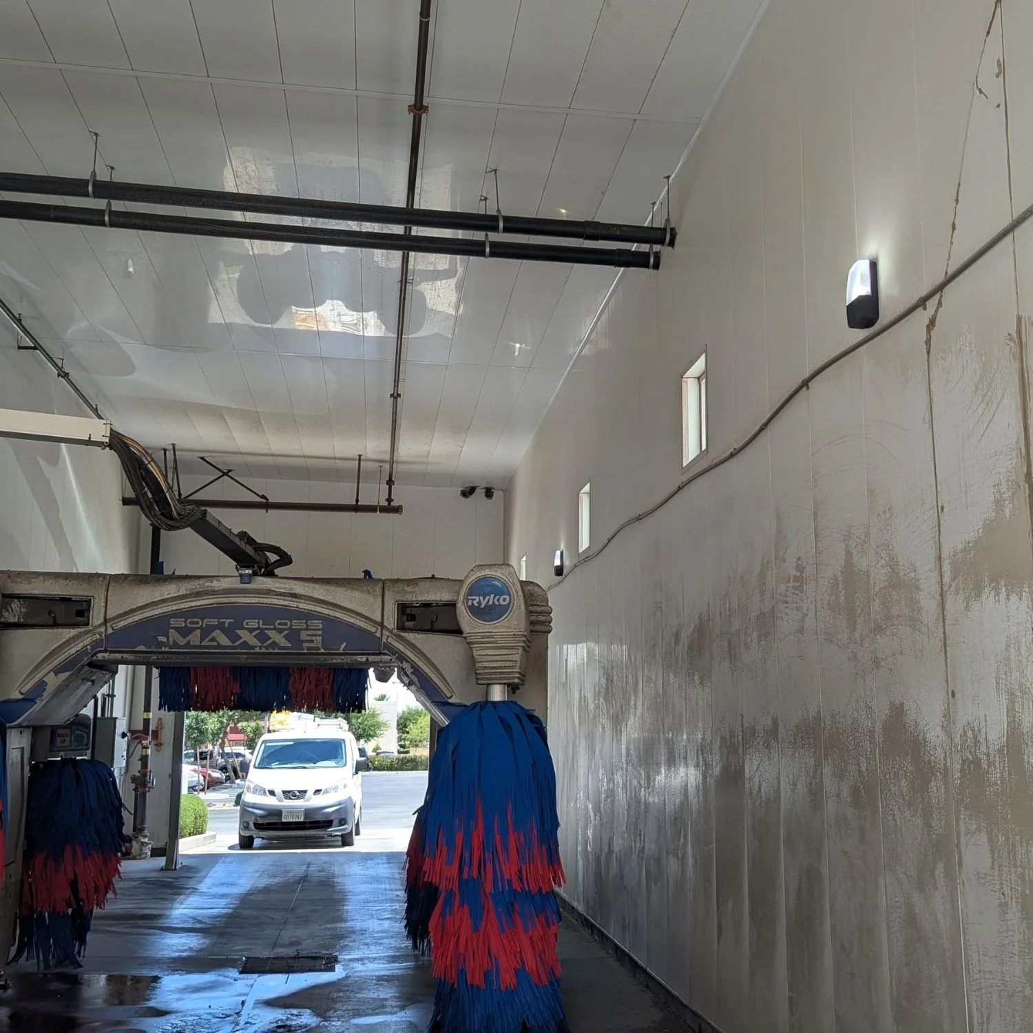 New Lithonia LED wall packs operating inside the Beyond Food Mart car wash in Hesperia after MTE Electric replaced the failed original lighting fixtures.