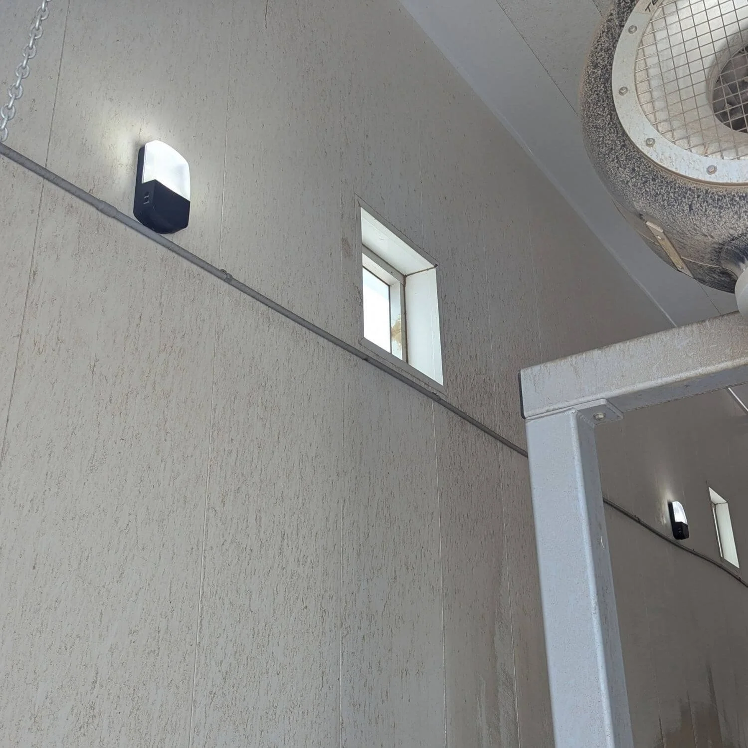 Multiple new Lithonia LED wall packs operating along the interior wall of the Beyond Food Mart car wash in Hesperia after MTE Electric replaced the failed fixtures.