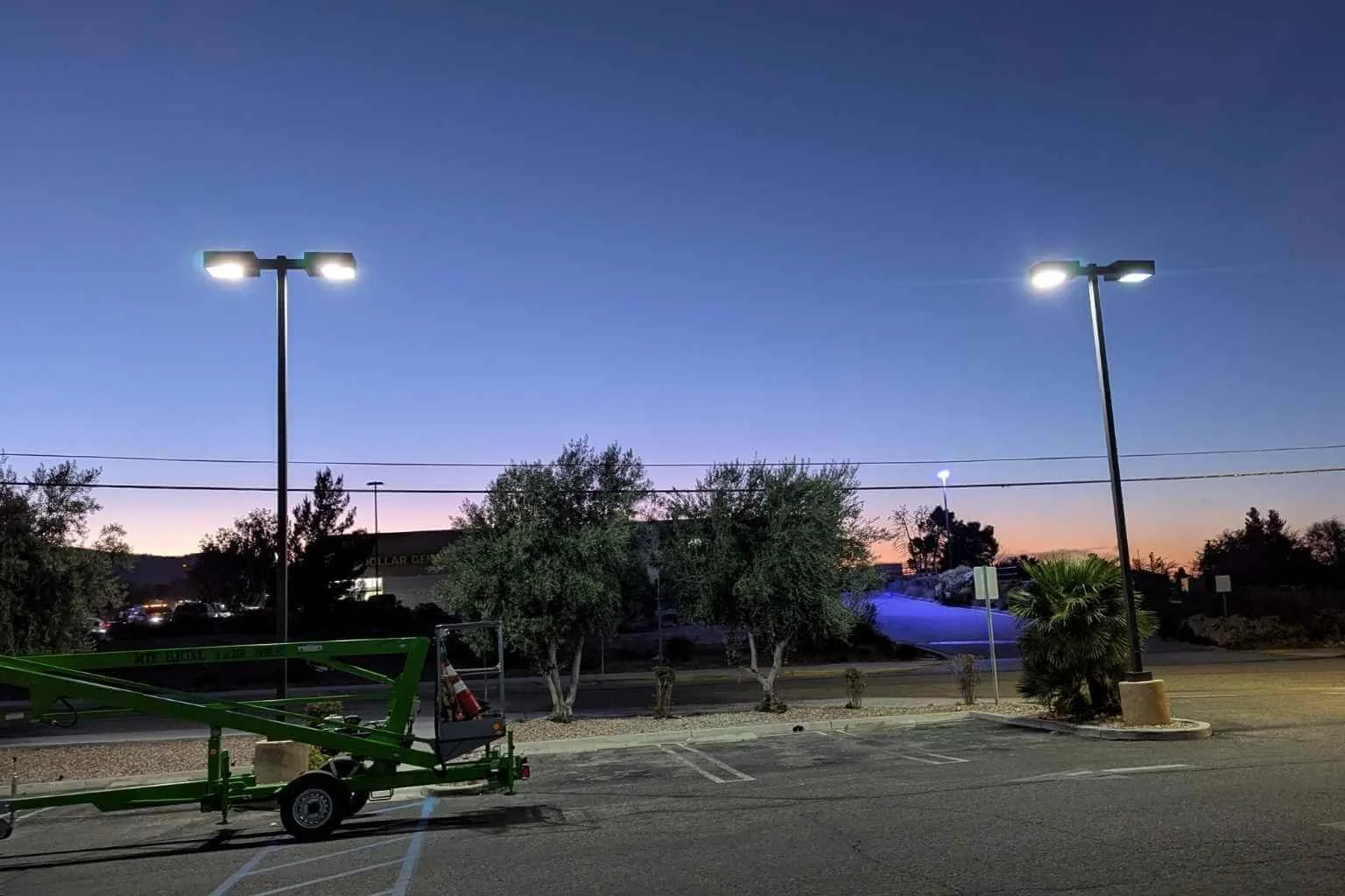 LED parking lot lighting upgrade completed by MTE Electric at Family Medical Center in Phelan, California, featuring eight upgraded parking lot light fixtures illuminated at dusk.