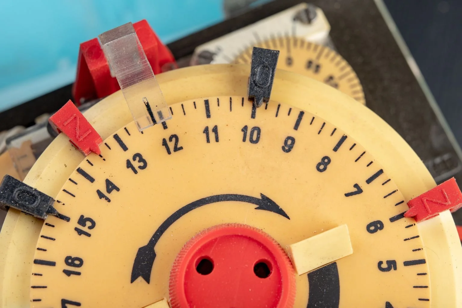 Close-up of a mechanical timeclock used for industrial lighting controls, maintained by a professional electrician in Apple Valley.