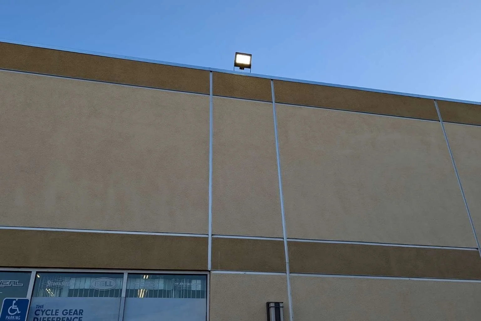 New LED floodlight installed by MTE Electric above the Cycle Gear building in Victorville, CA to improve parking lot lighting and nighttime visibility.