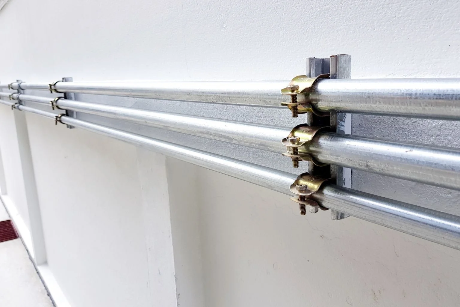 Electrician in Victorville installing metal conduit for commercial electrical wiring.
