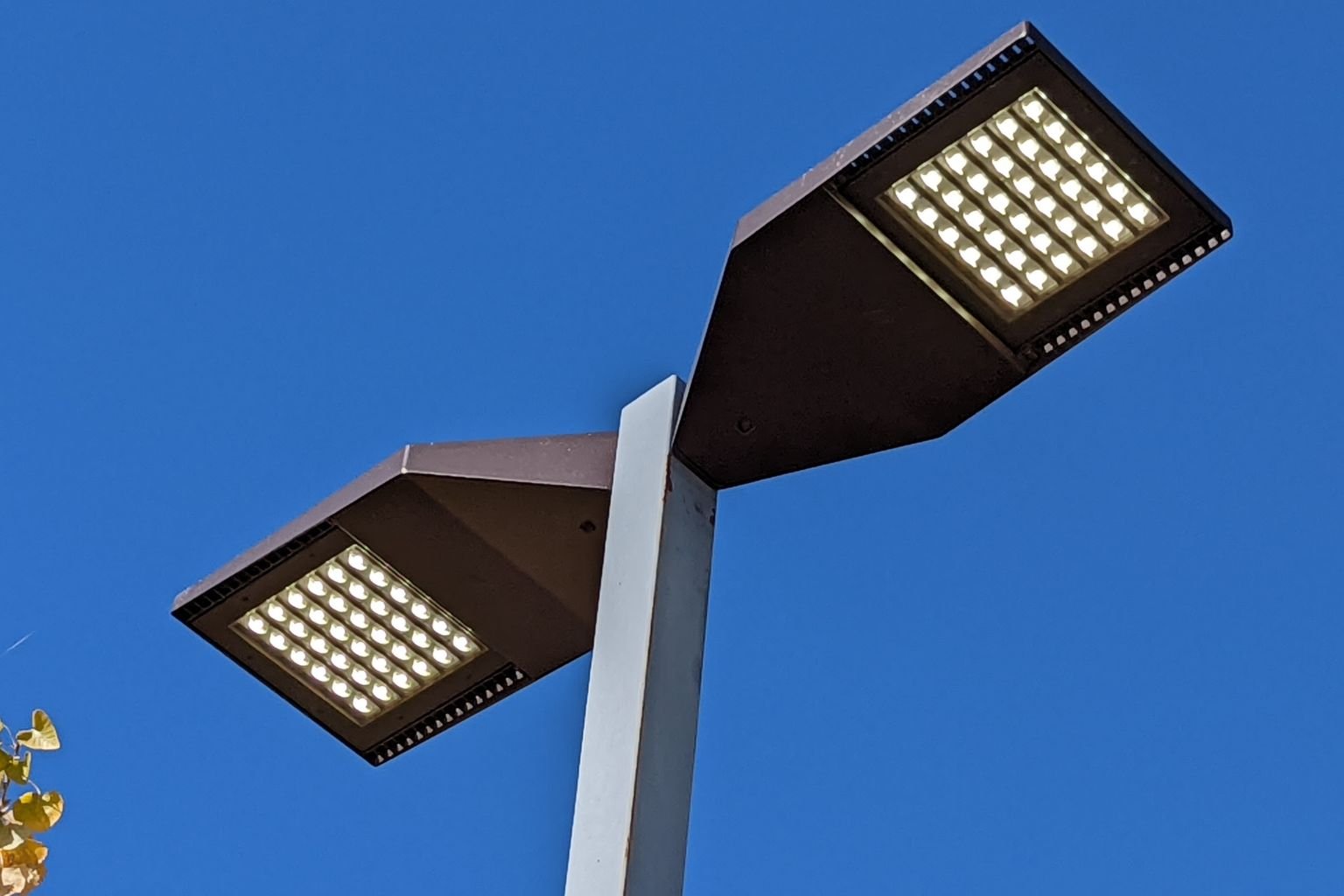 LED parking lot light fixtures installed by electrician at a service station in Apple Valley California, replacing metal halide lights.