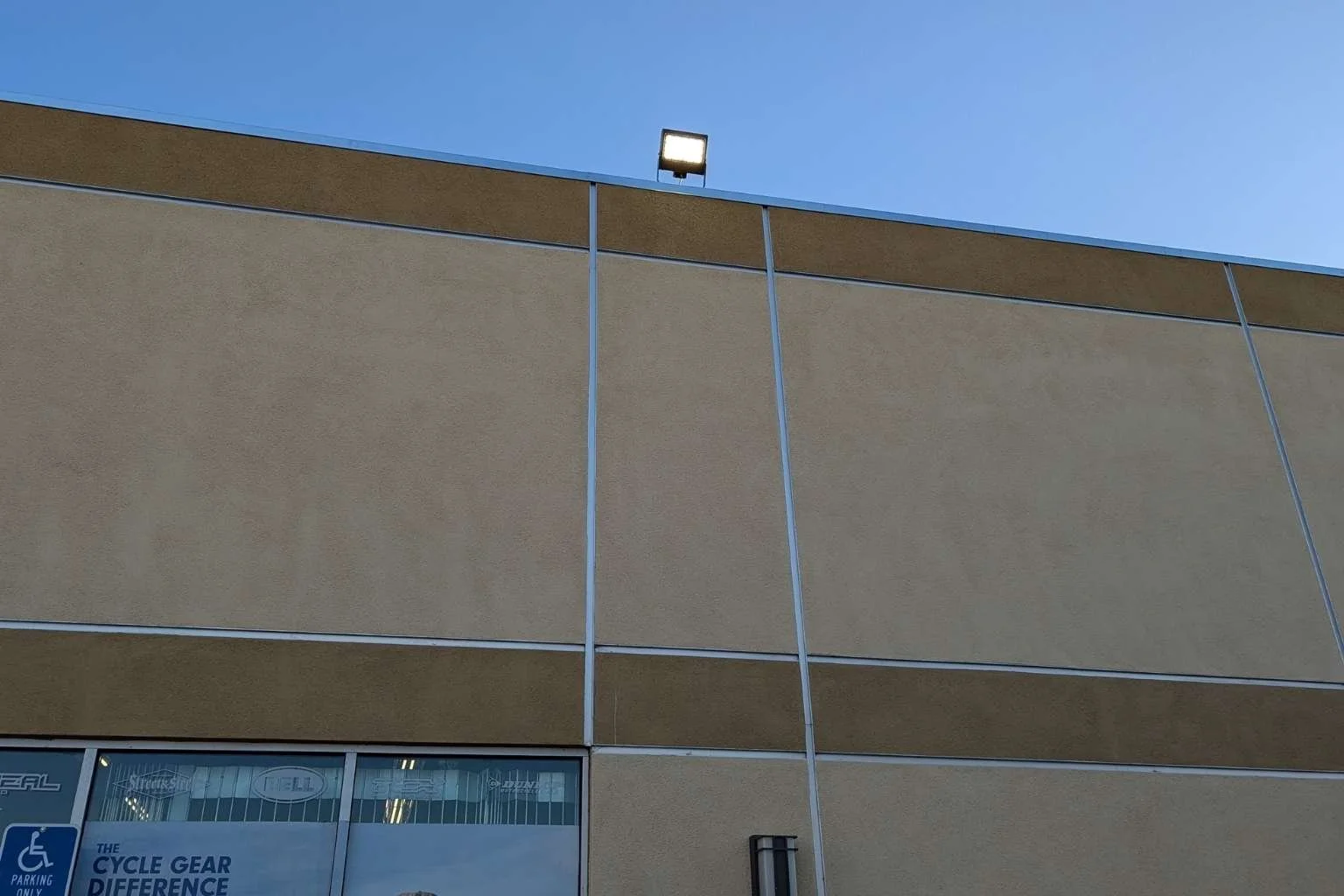 Commercial Westgate LED flood light providing improved parking lot lighting at Cycle Gear in Victorville California.