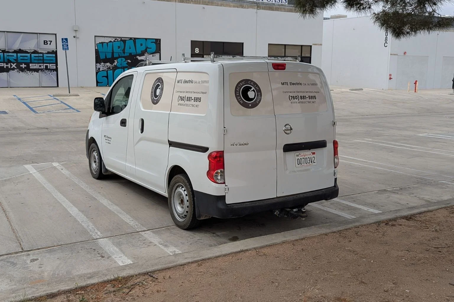 MTE Electric commercial electrician vehicle at an industrial property.