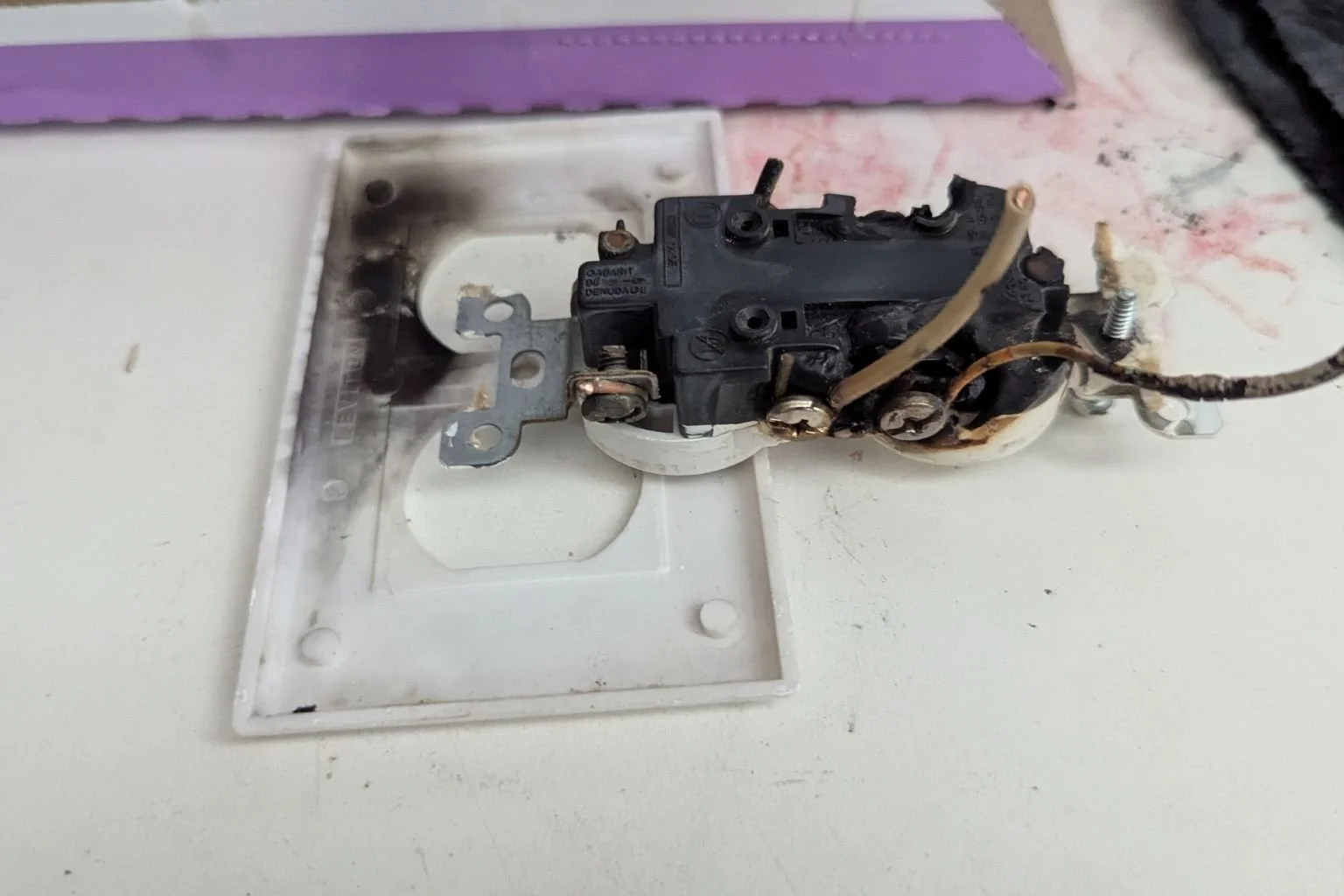 Burnt electrical outlet removed during troubleshooting and repair service in Apple Valley California.
