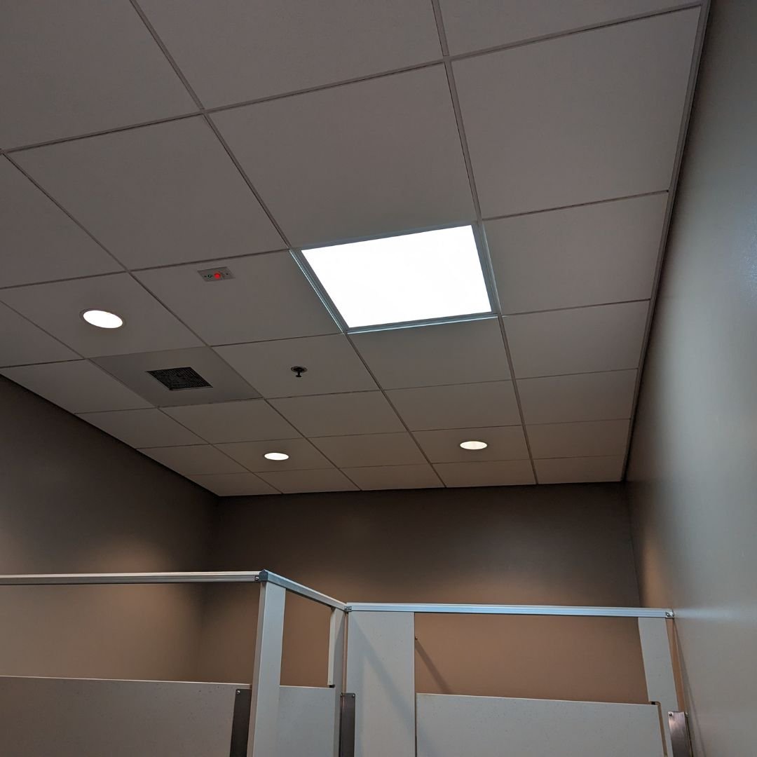 Emergency lighting upgrade in Apple Valley, California—our electrician replaced a failed recessed CFL fixture with a new 2'x2' LED flat panel equipped with emergency battery backup, providing brighter and more reliable illumination in this office res