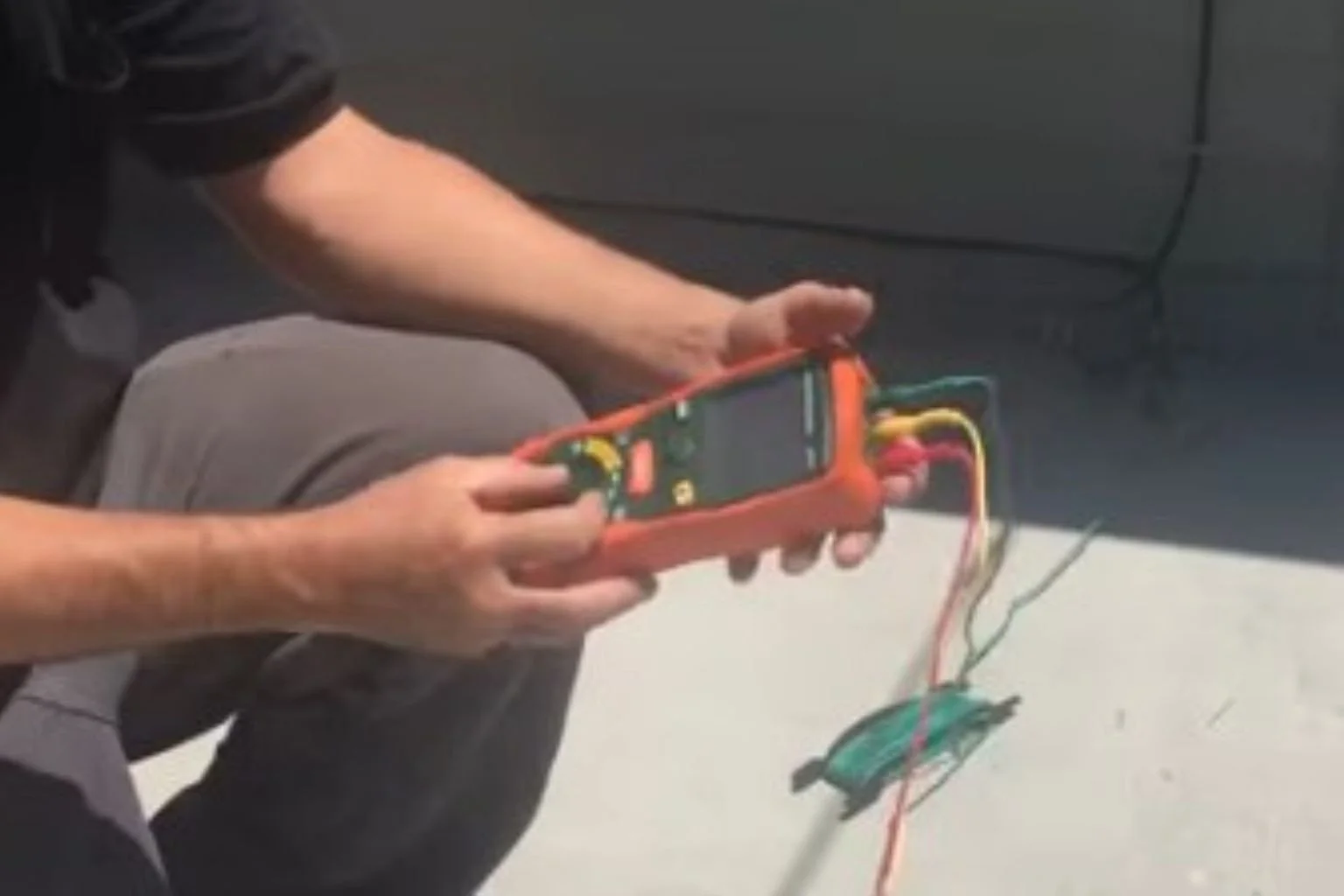 Electrician testing a ground rod for electrical resistance.