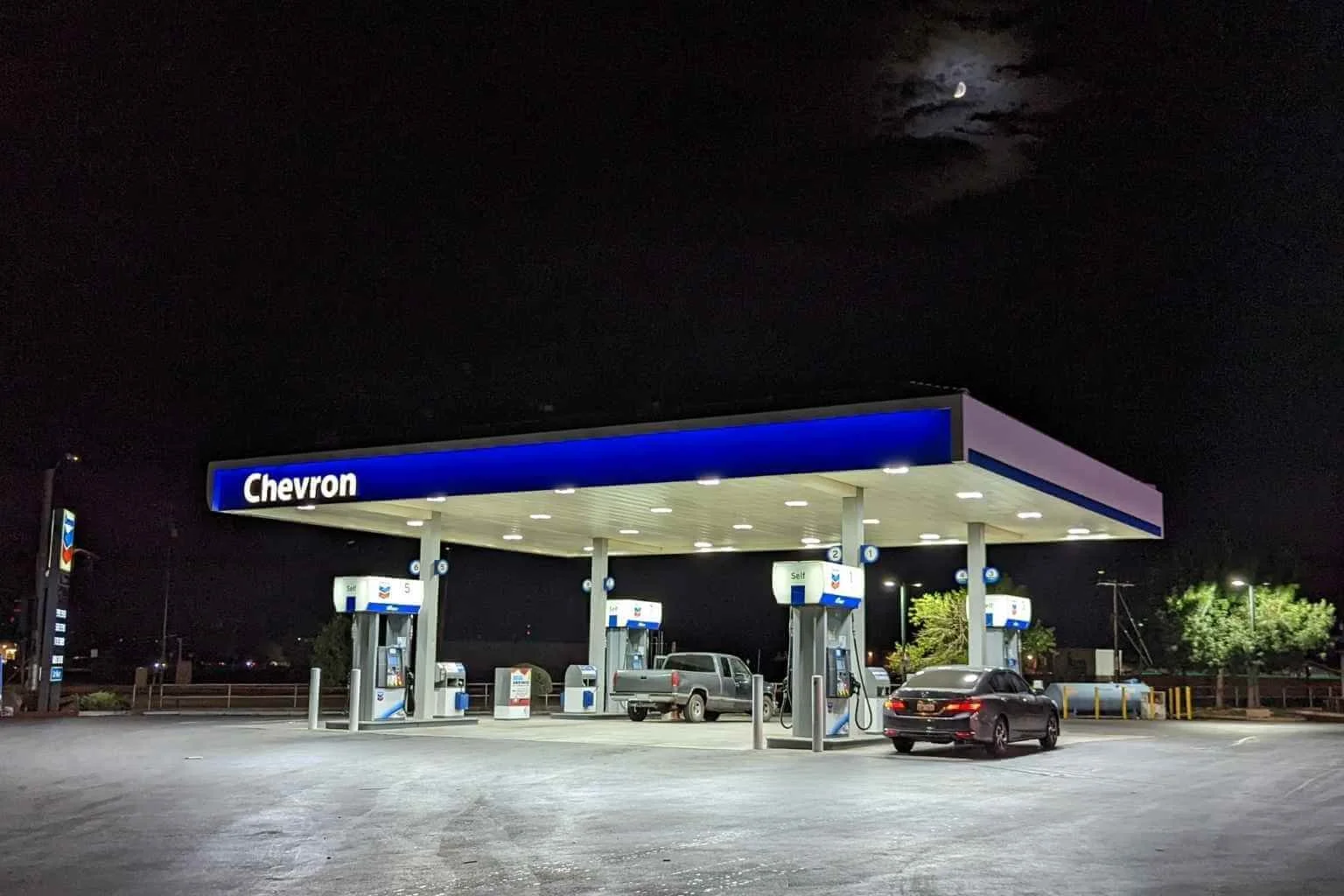 Commercial electrician replaced metal halide canopy light fixtures with new LSI LED canopy fixtures at a Chevron station in Apple Valley, providing brighter illumination, improved energy efficiency, and enhanced visibility for customers.