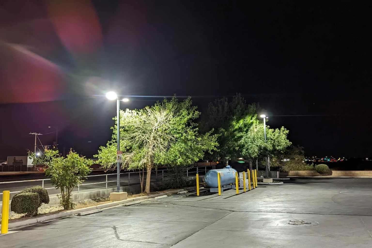 Commercial electrician upgraded parking lot lighting at a Chevron station in Apple Valley by replacing metal halide fixtures with energy-efficient LSI LED parking lot light fixtures, improving nighttime visibility and safety.