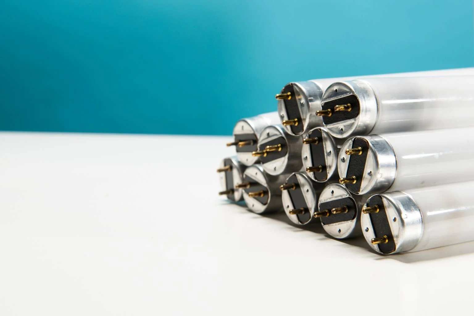 Stack of fluorescent tube lamps showing proper disposal and recycling in California
