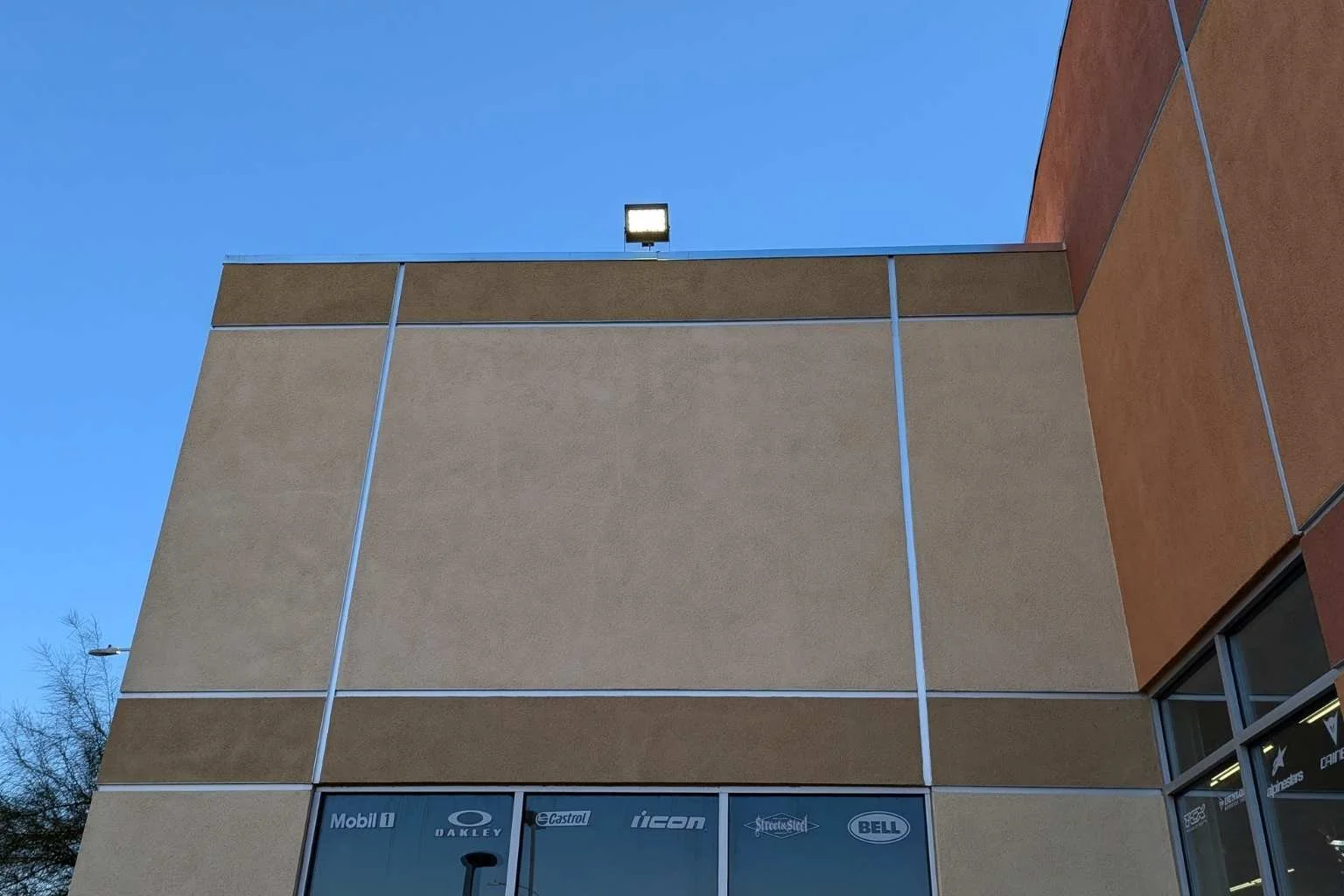 Commercial Westgate LED flood light installed above Cycle Gear storefront in Victorville California by MTE Electric.