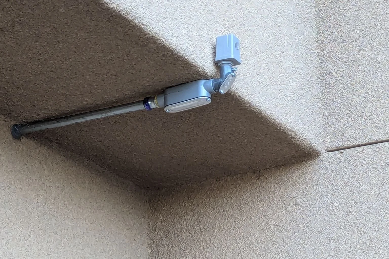 Our electrician replaced a timeclock with a photo-control for the parking lot light poles at this Phelan, California bank.