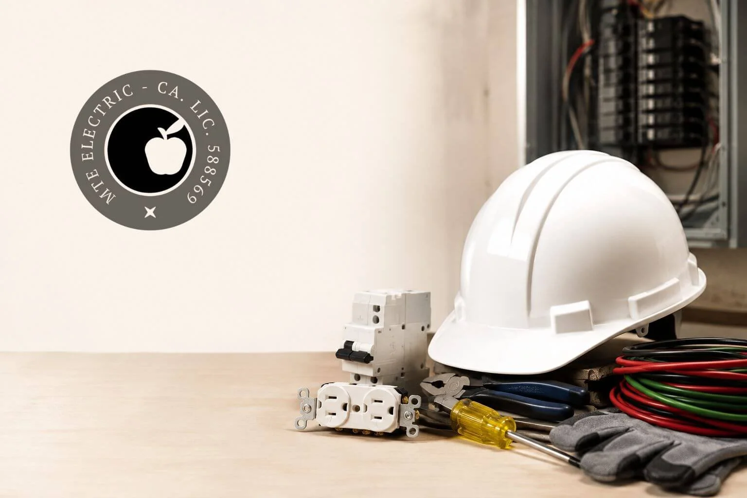 Electrical tools, safety equipment, and an electrical panel representing MTE Electric's commercial insurance coverage.
