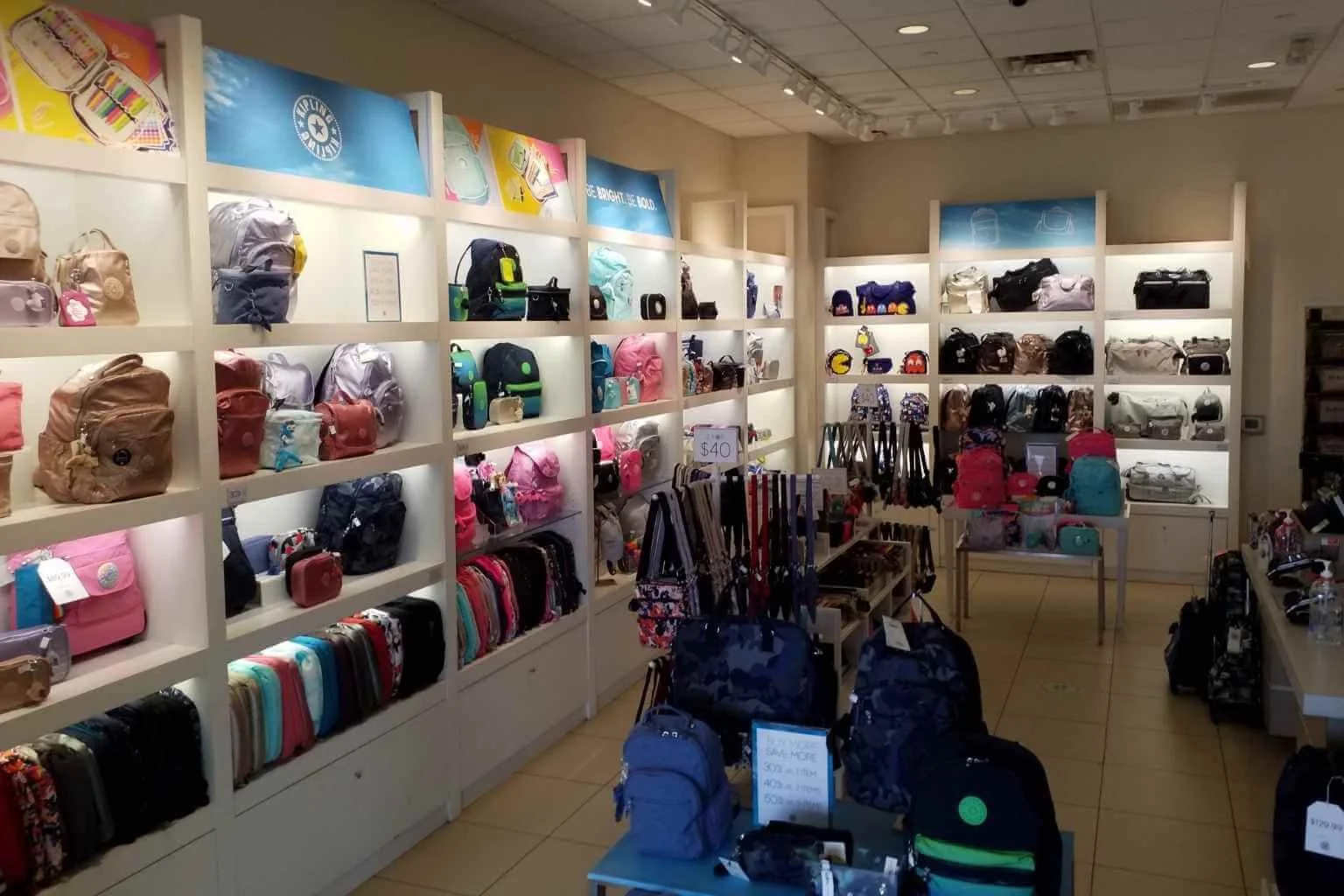 Commercial electrician restoring merchandise display lighting in a Barstow retail store by replacing faulty fluorescent ballasts and burned-out linear fluorescent lamps to improve product visibility.