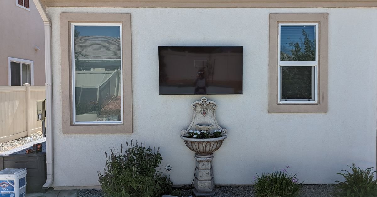 Outdoor wall-mounted flat screen TV installed and powered by professional electrician in Apple Valley, California.