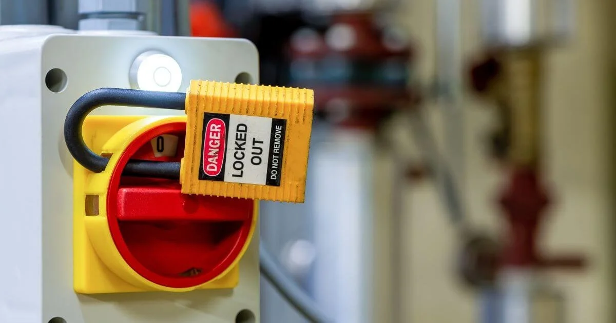 Electrical disconnect secured in the off position with a lockout device and safety lock to prevent unintended re-energization during electrical work.
