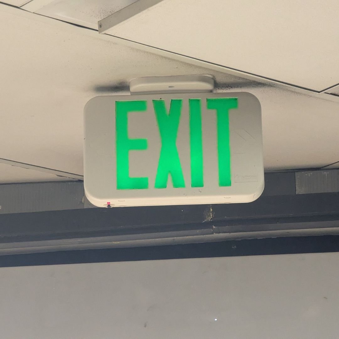 A new emergency exit sign installed by our electrician at a convenience store in Apple Valley, improving safety and code compliance with reliable emergency lighting.
