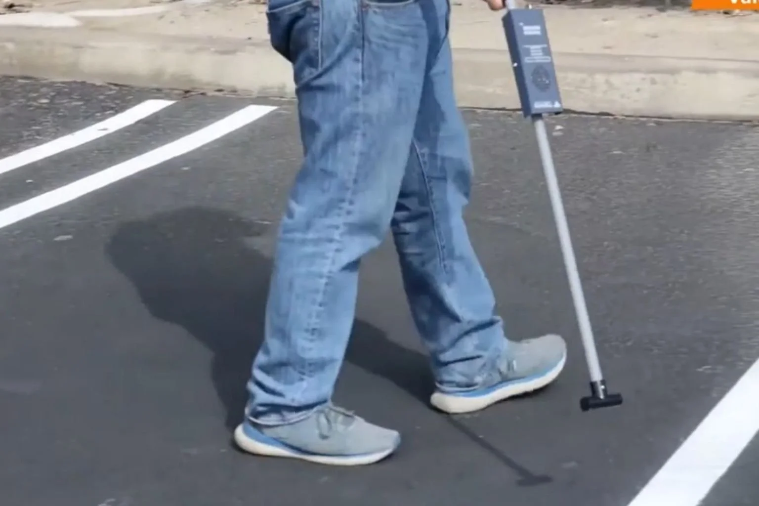 Electrician tracker underground electrical wires in a parking lot.