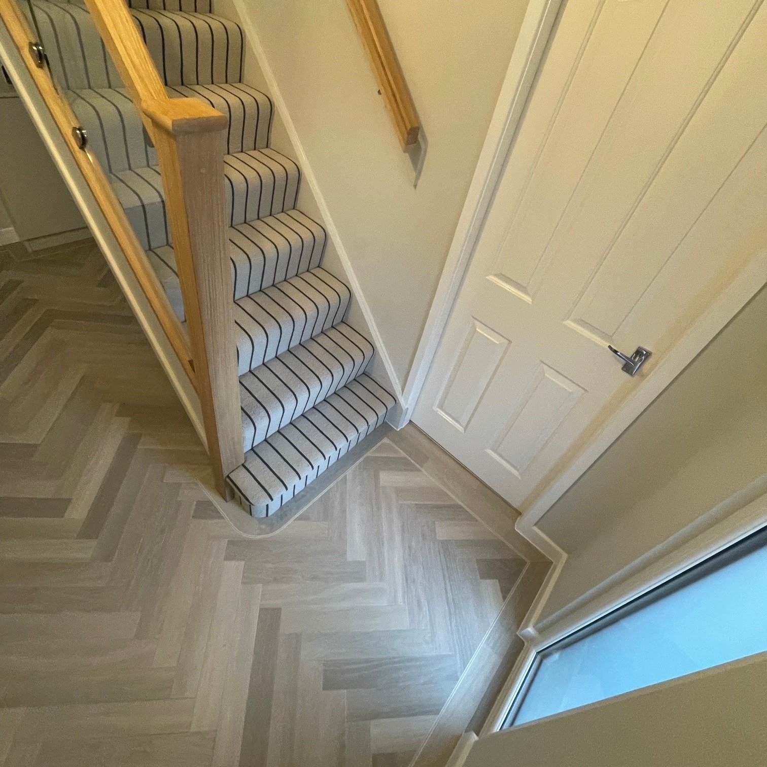 A transformation in this customer's Hallway, earlier last year we fitted @karndean_uk Art Select - Glacier Oak SM-RL21 in their Lounge. Our customer decided to continue this through into the Hallway and chose a bold stripe carpet for the Stairs &amp;