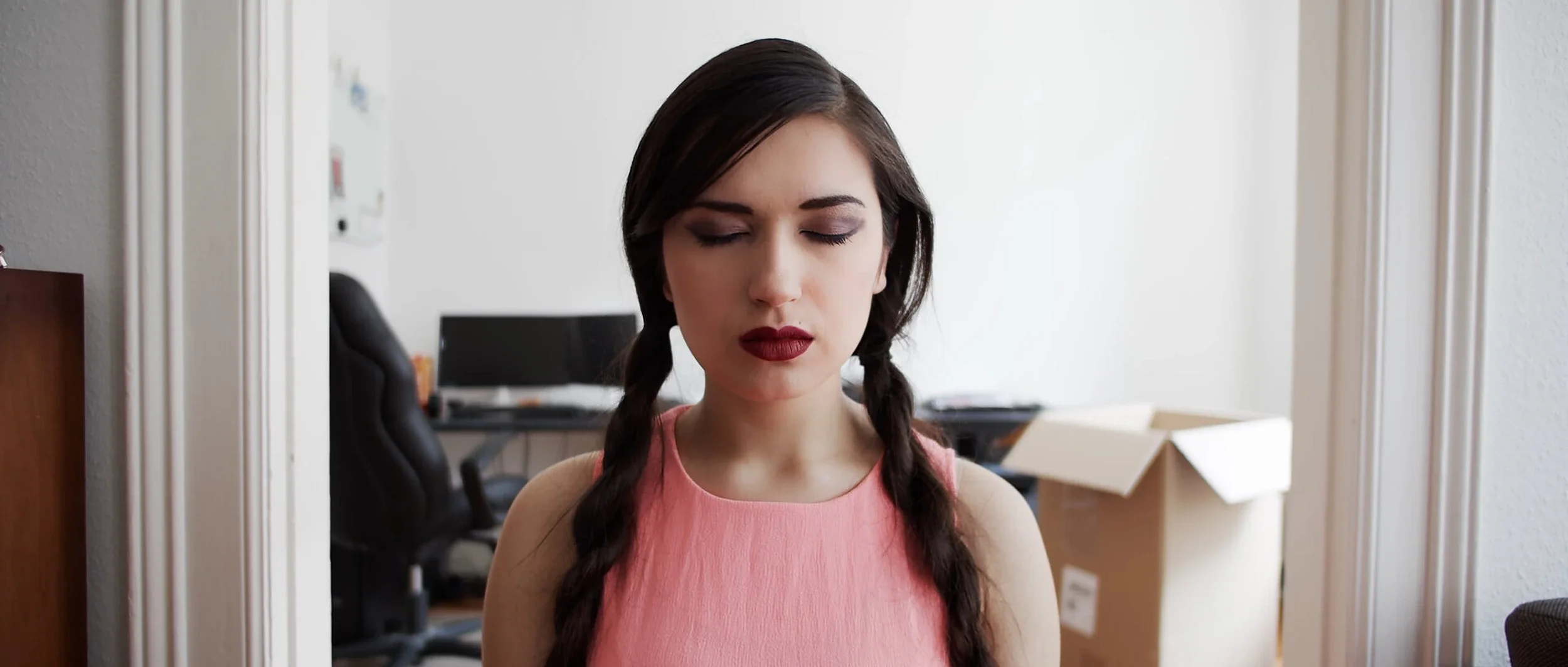 ava-short-film-young-woman-braids-office.webp