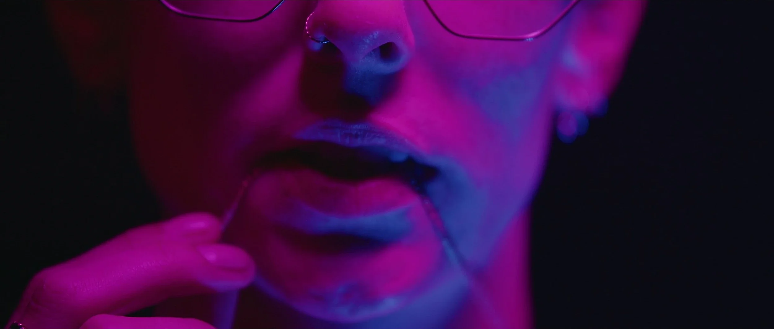 obsession-short-film-neon-magenta-face-closeup.webp