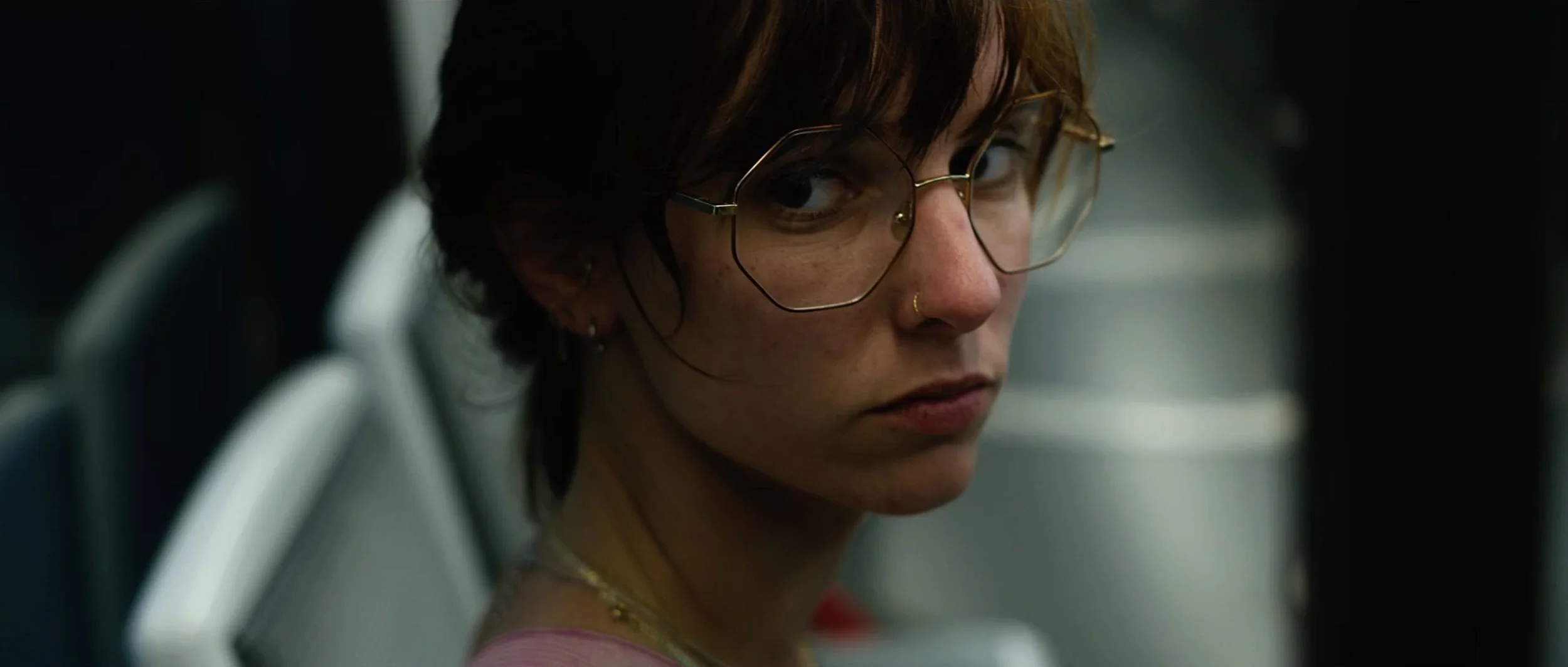 obsession-short-film-woman-glasses-teal-light.webp