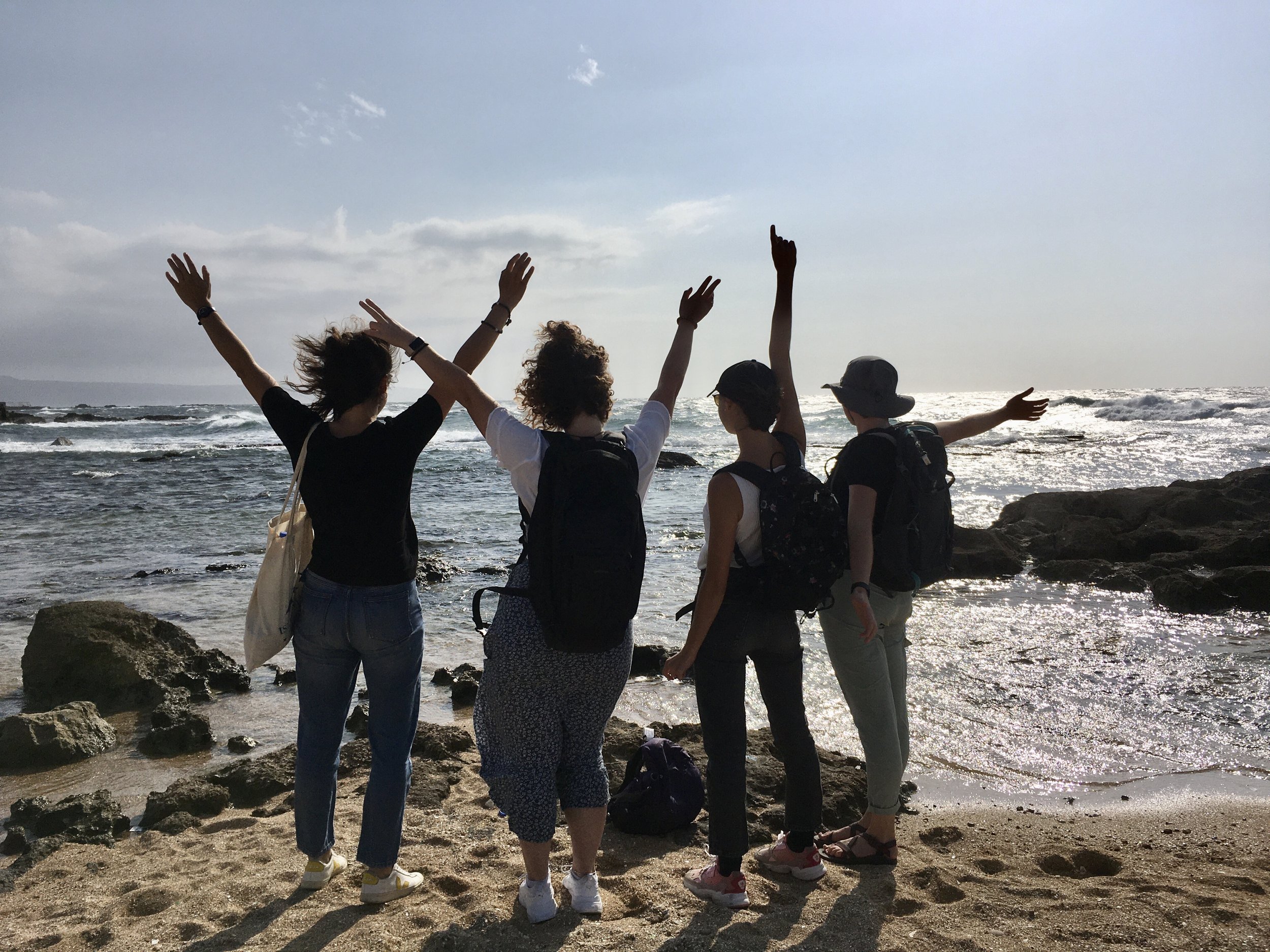 Several of our group enjoying the strong winds that surprised us by the seaside
