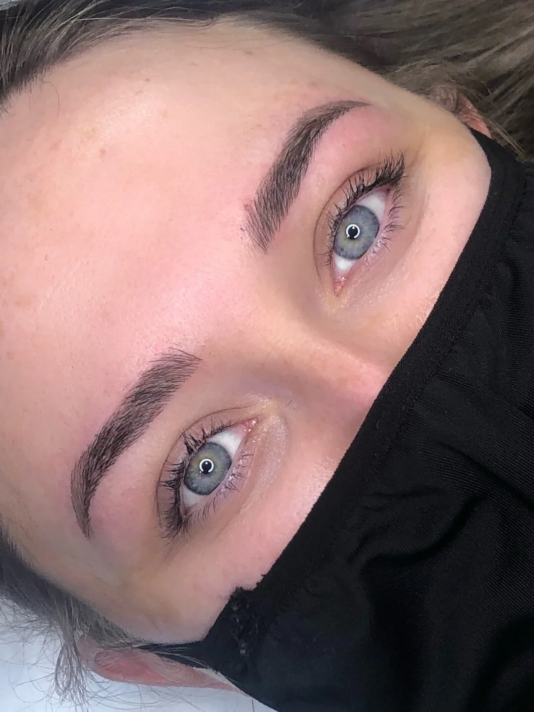 An image of a woman with freshly microbladed eyebrows.