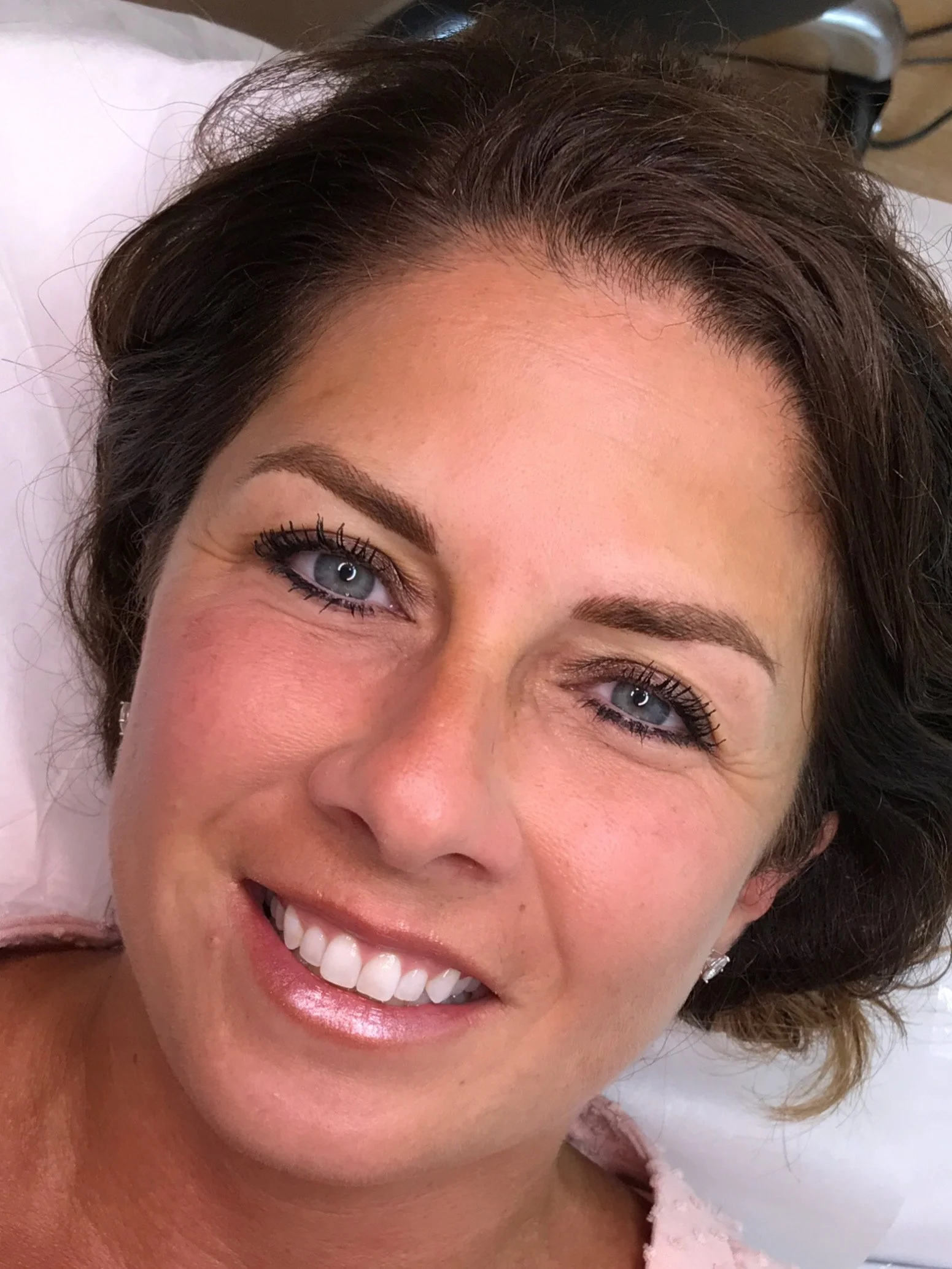 Close-up of a woman with freshly tattooed eyebrows.