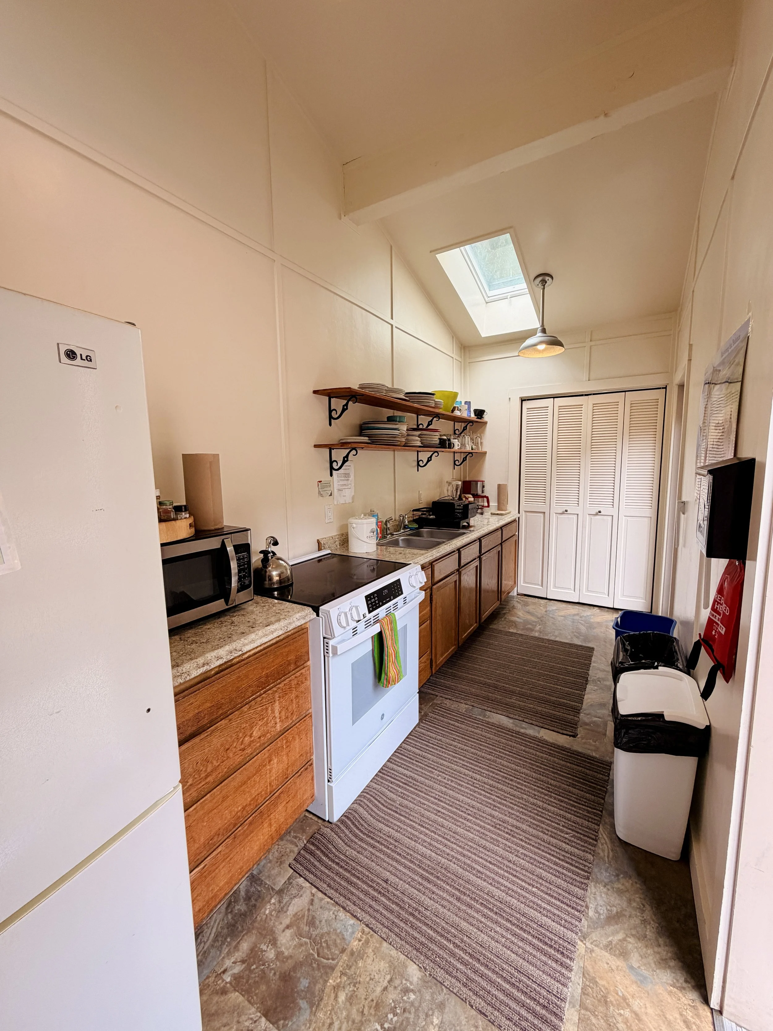 Shared Kitchen - The Bunkhouse's galley kitchen is shared among the four Bunkhouse rooms.  A standard size refrigerator, 4 burner electric range, microwave, and drip coffee pot making meal prep easy.  Basic cookware, dishes, and utensils are provided