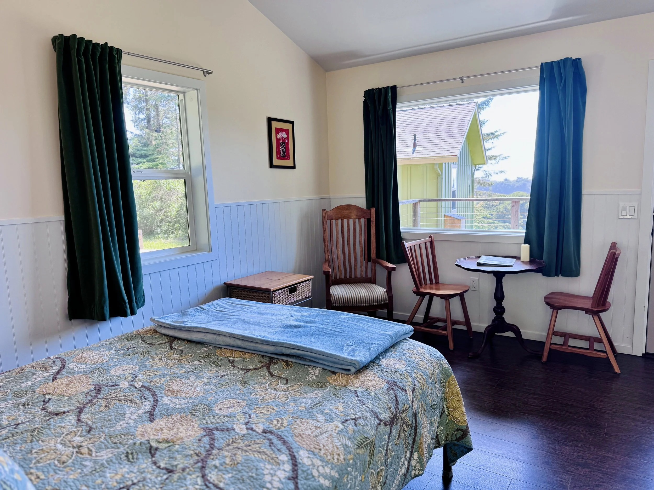 Pelican Interior - One queen bed, small sitting area; large picture window overlooking our expansive lawn and the Pacific Ocean
