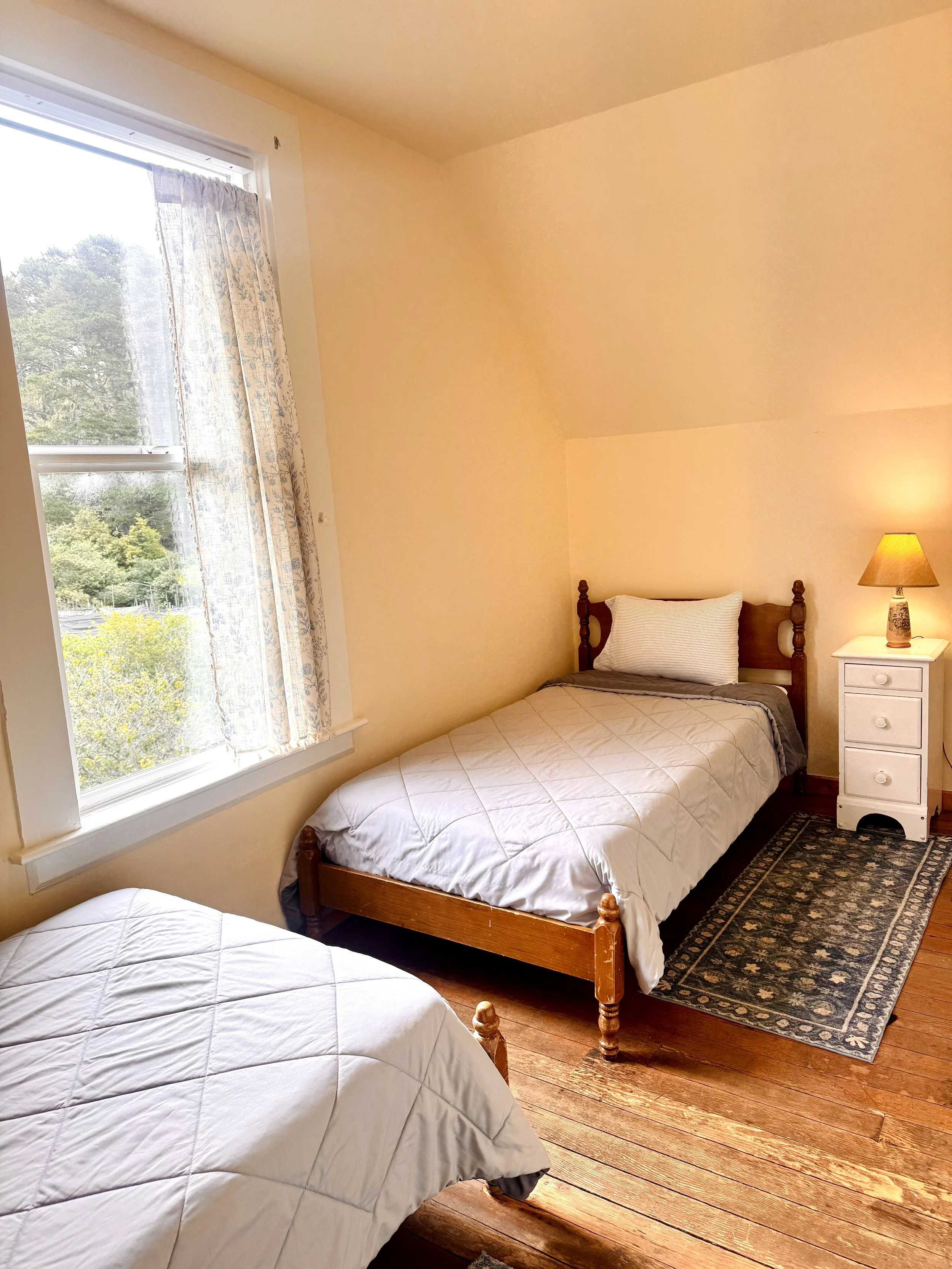 Bedroom #3 - The Garden Room - features two twin beds and a view of our expansive orchard meadow