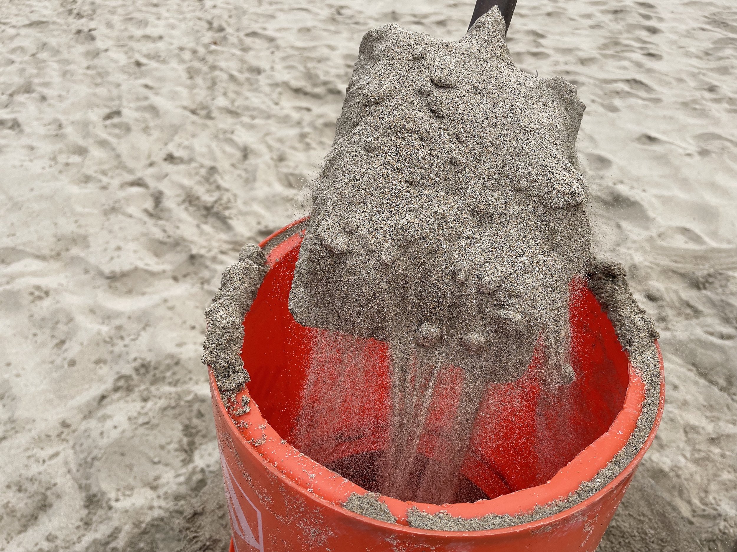 put sand in your bucket form to create a sand castle