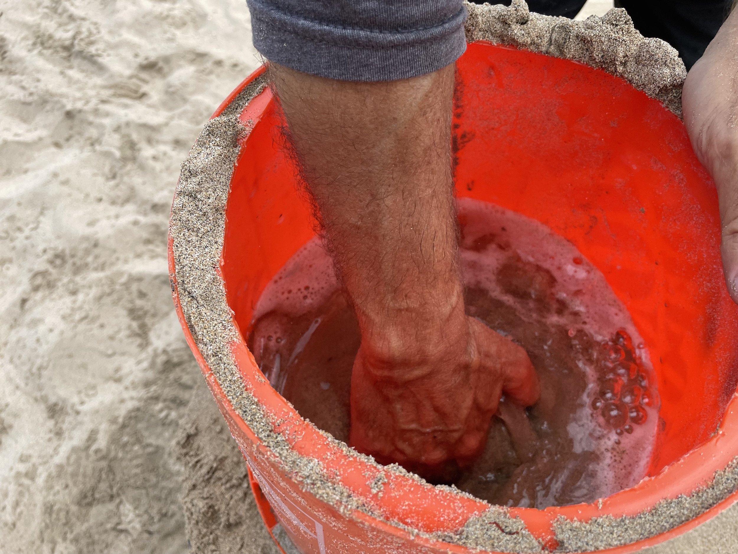 use your hand to mix the sand in your form