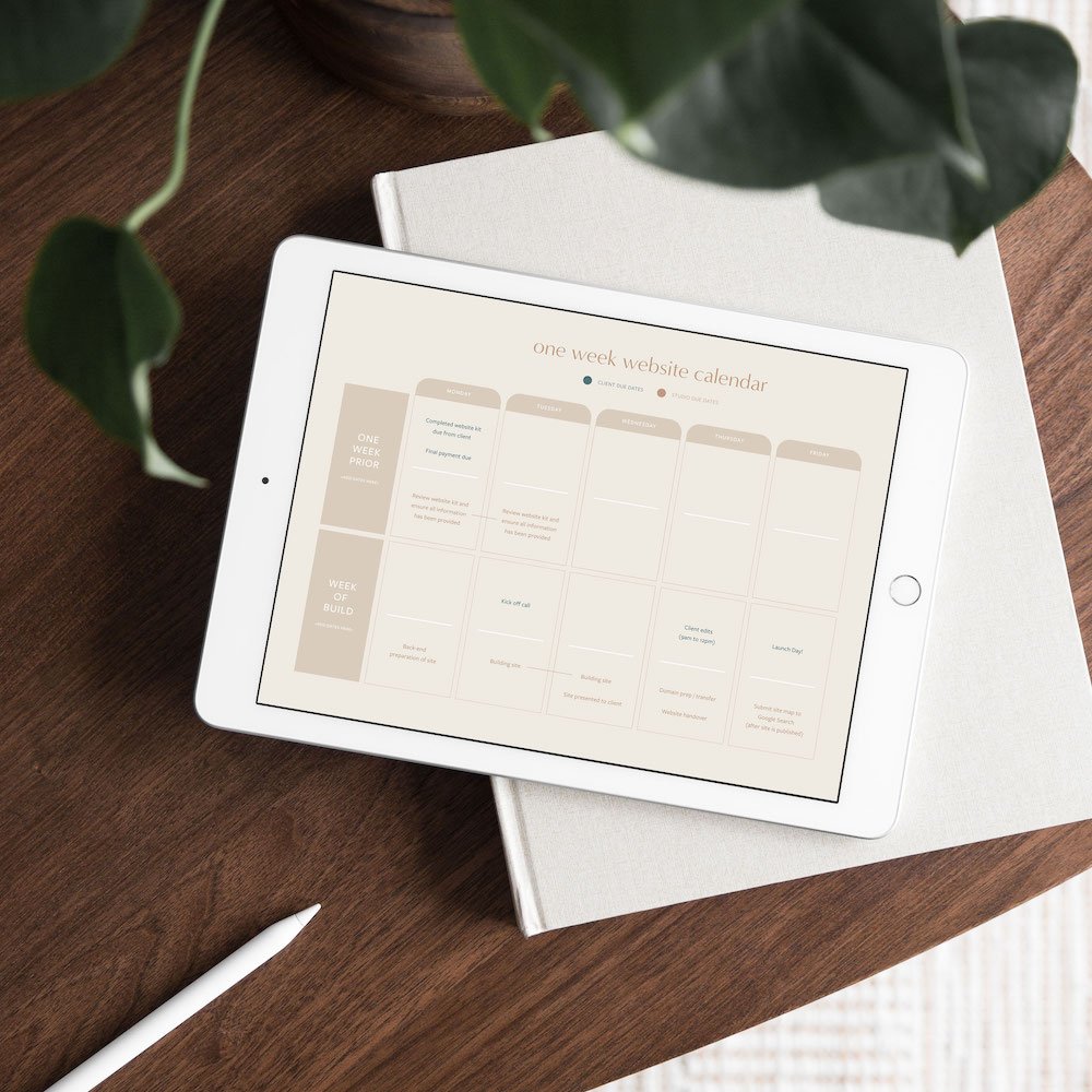 An iPad displays the one-week website key dates calendar, created by Alana Jade Studio.