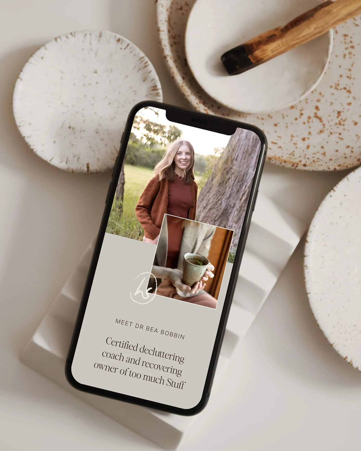 Hello Space website design for decluttering coach displayed on a smartphone, showing the about page hero with brand photography by Honey Atkinson
