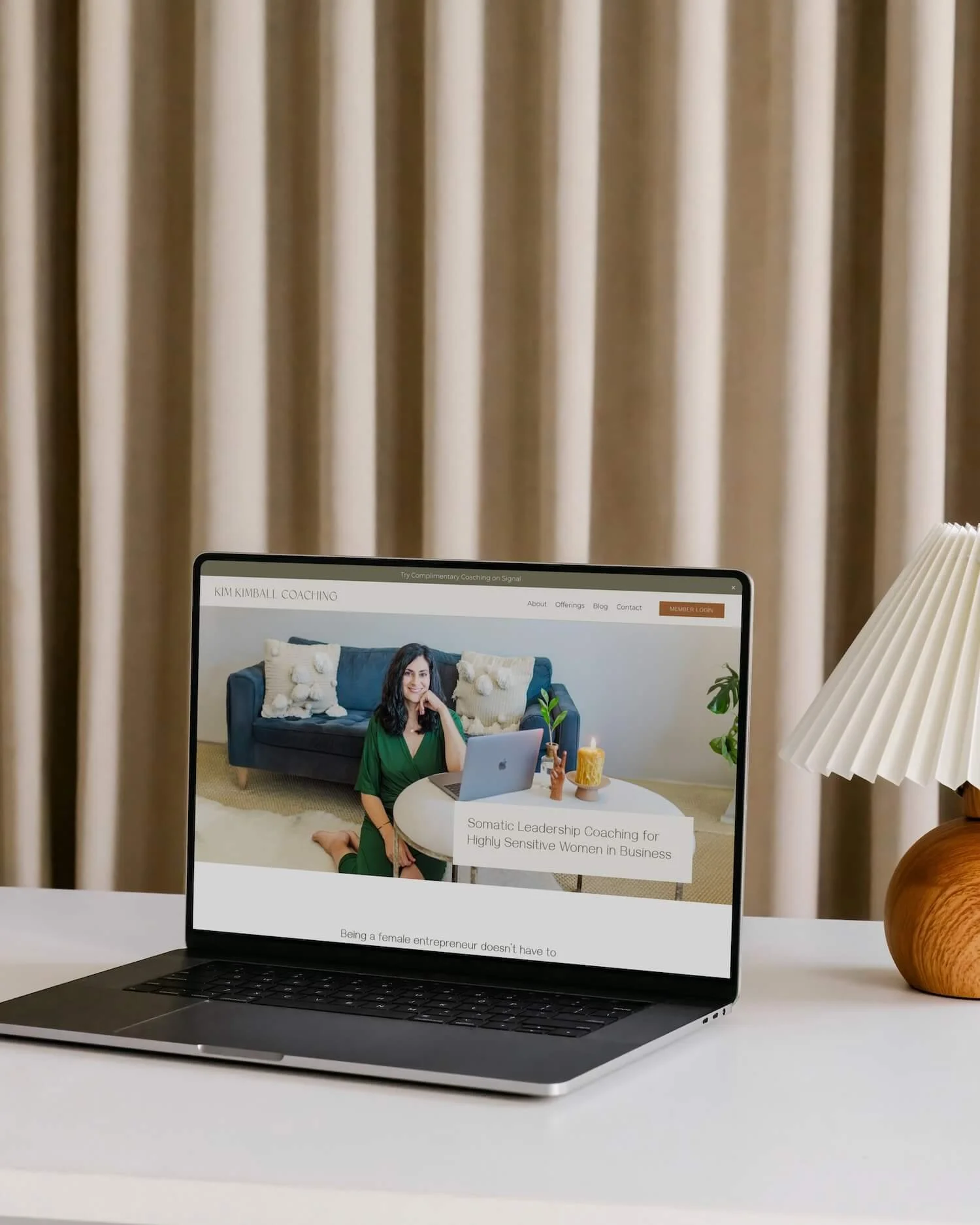 A laptop showing the home page hero section for a neurodivergent business coach