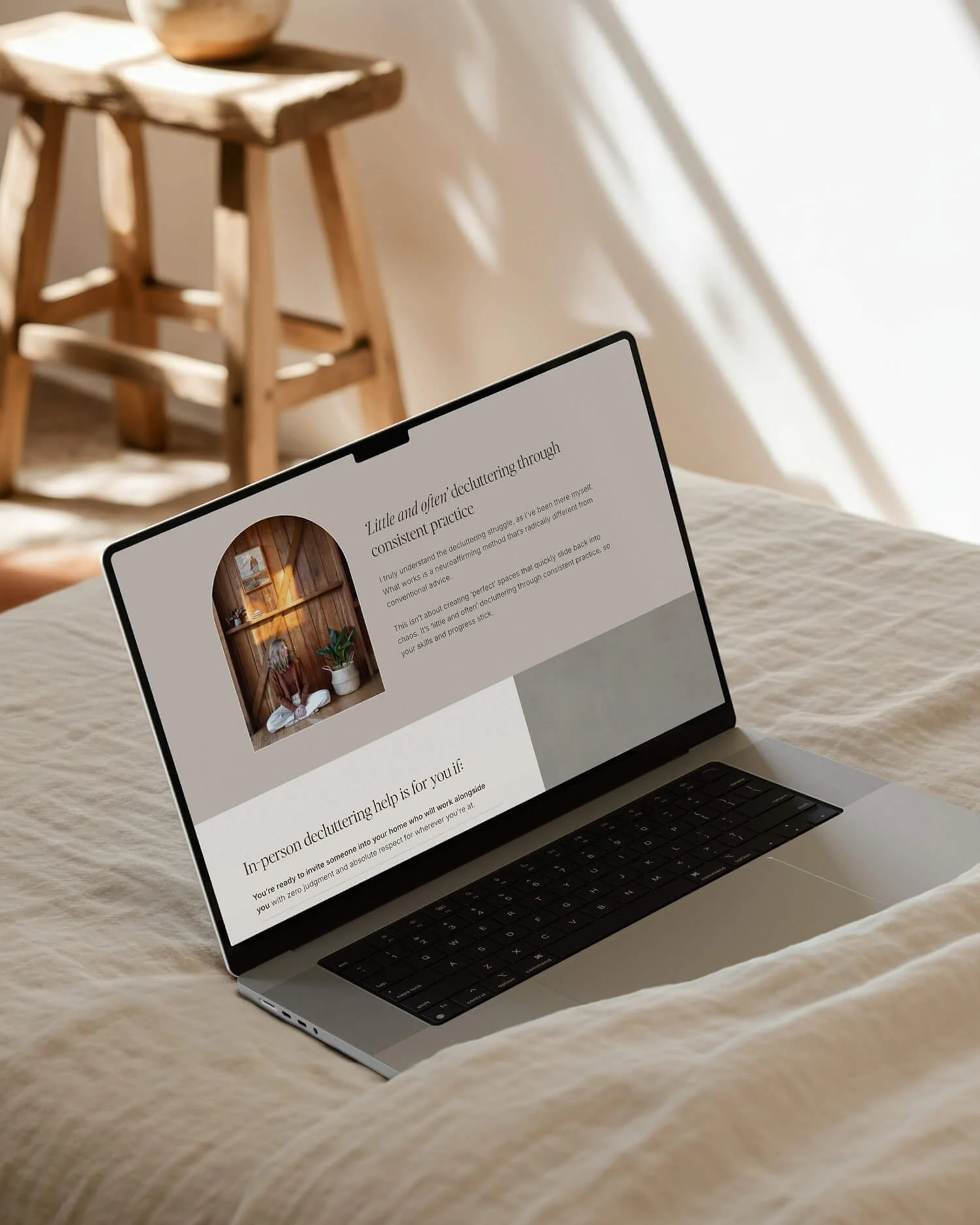 Hello Space decluttering coach website design on a MacBook, showing a service page with arched image.